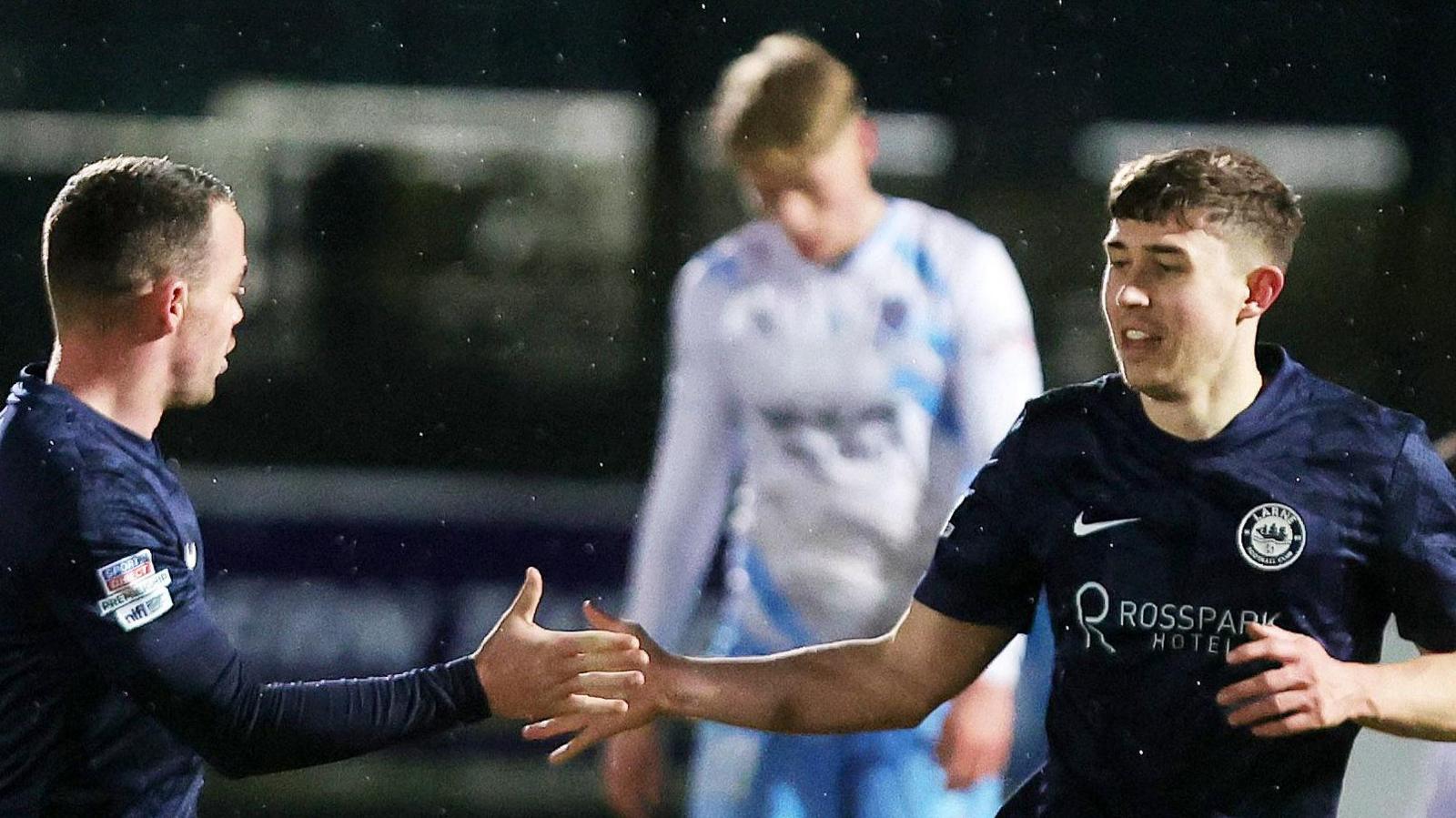 Paul O'Neill (right) celebrates scoring the opener for Larne against Ballymena