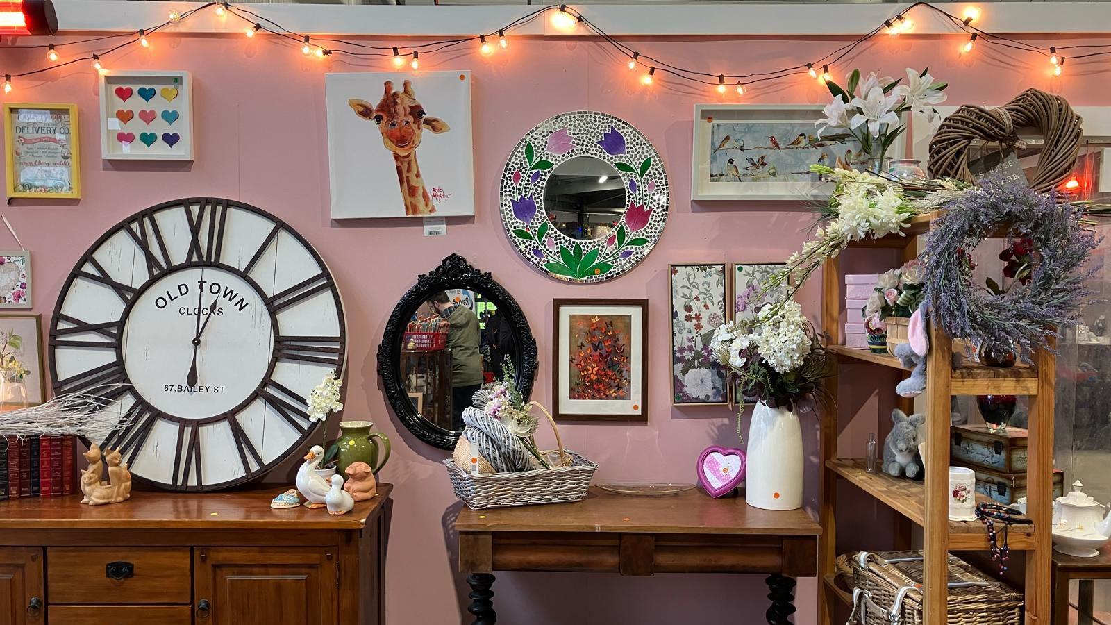 Pink shop wall covered in bric-a-brac