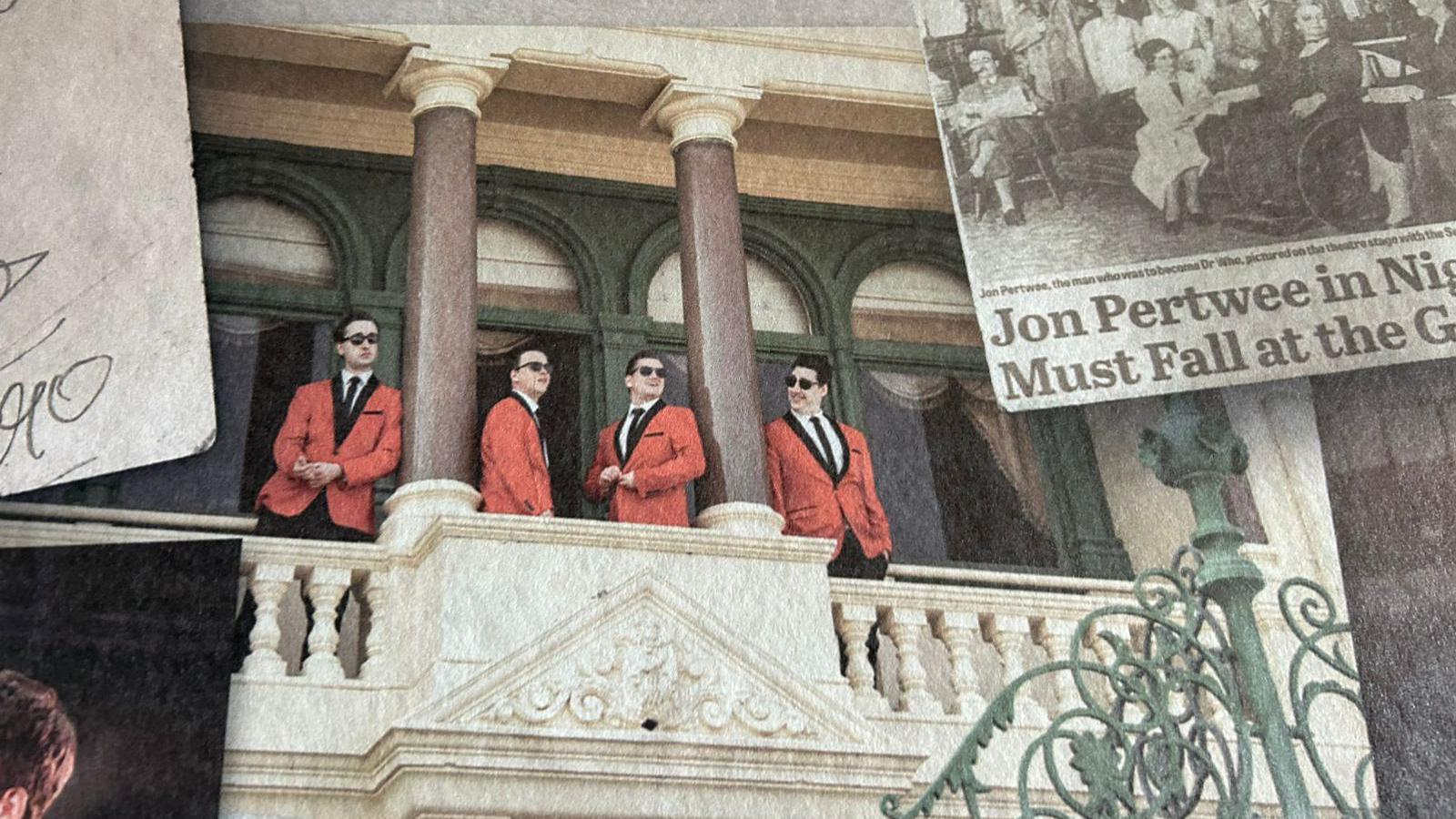 Part of the mural showing the Jersey Boys actors posing on a balcony wearing red jackets.