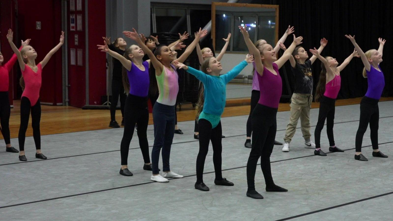 The children pose for the end of a musical number.