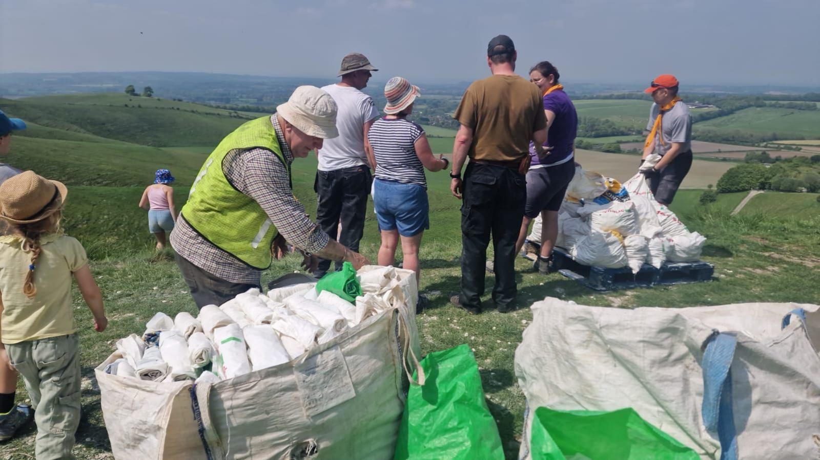 A group of people standing around bags of chalk