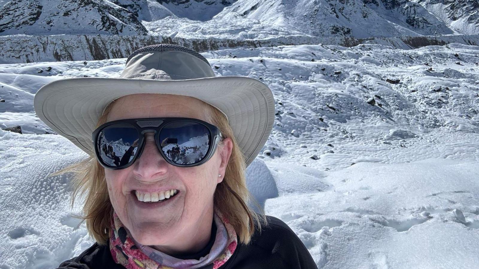 Gillian smiling surrounded by snow and mountains