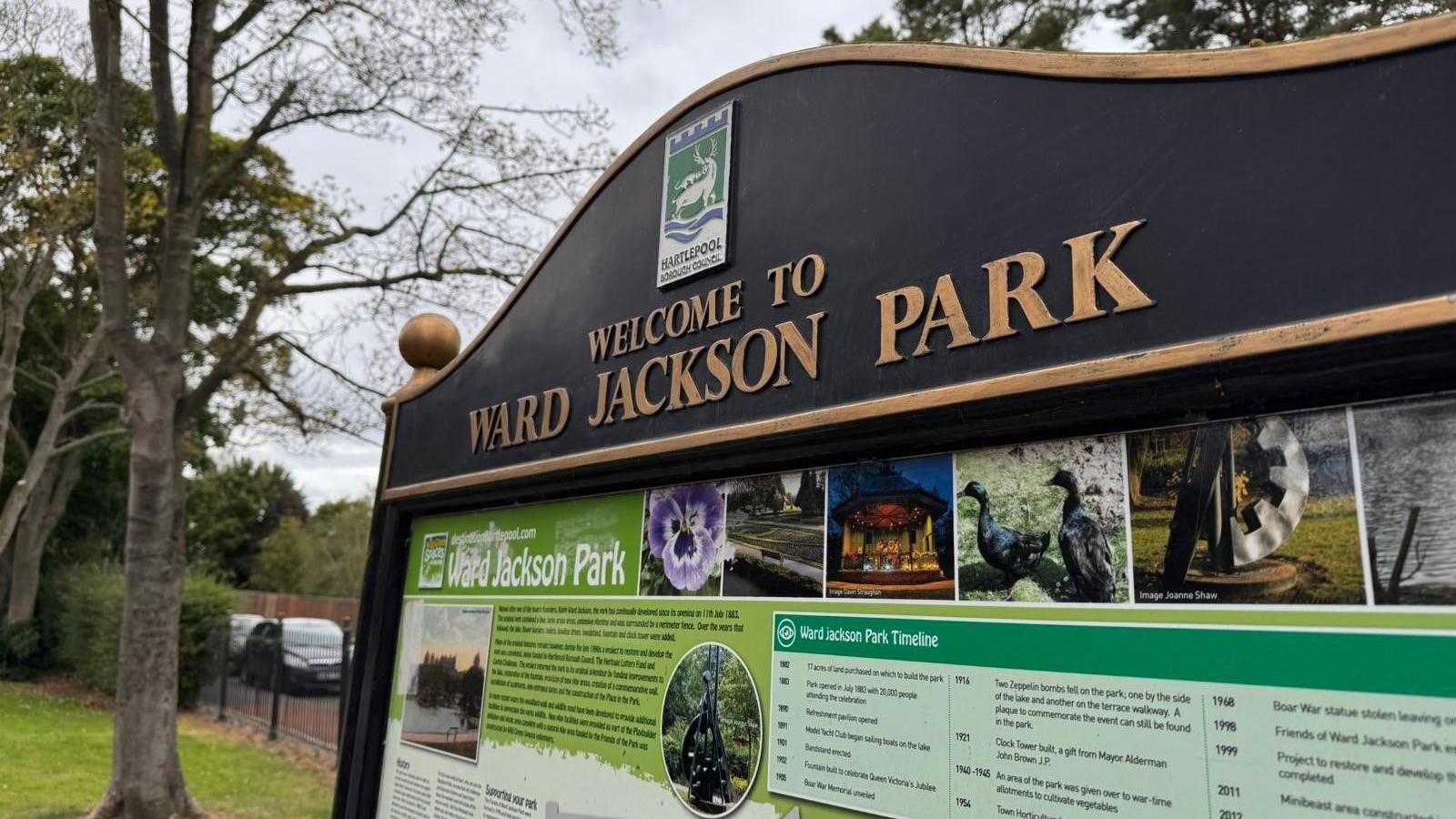 The picture shows a panel with the words Ward Jackson park on with lots of information and a few trees in the background.