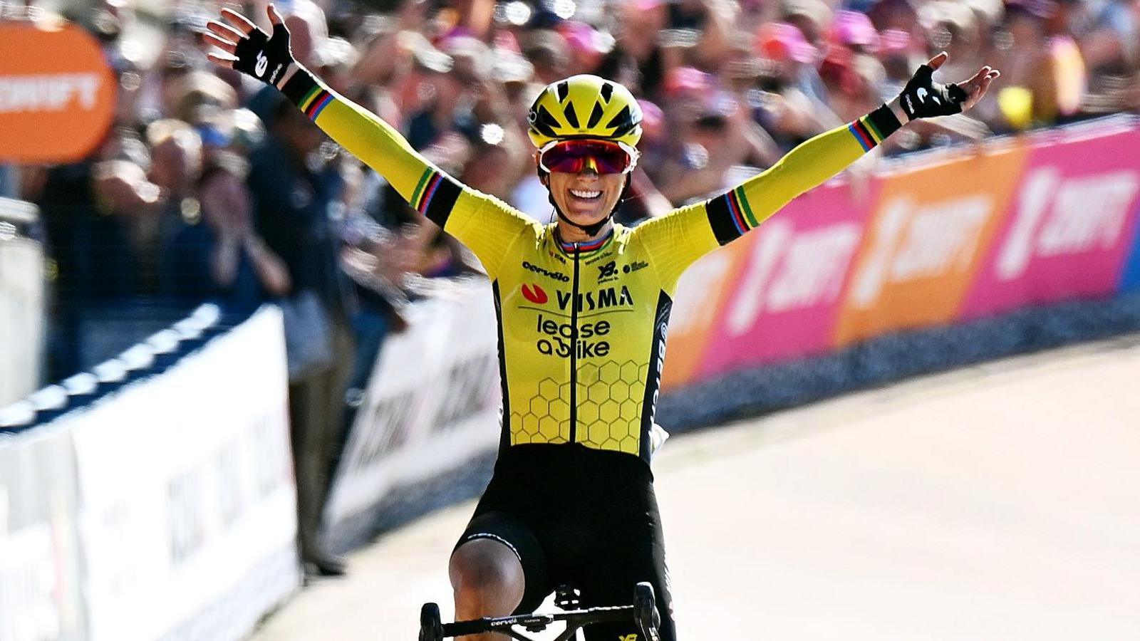 Pauline Ferrand-Prevot raises her arms in celebration after crossing the line to win the Paris-Roubaix race
