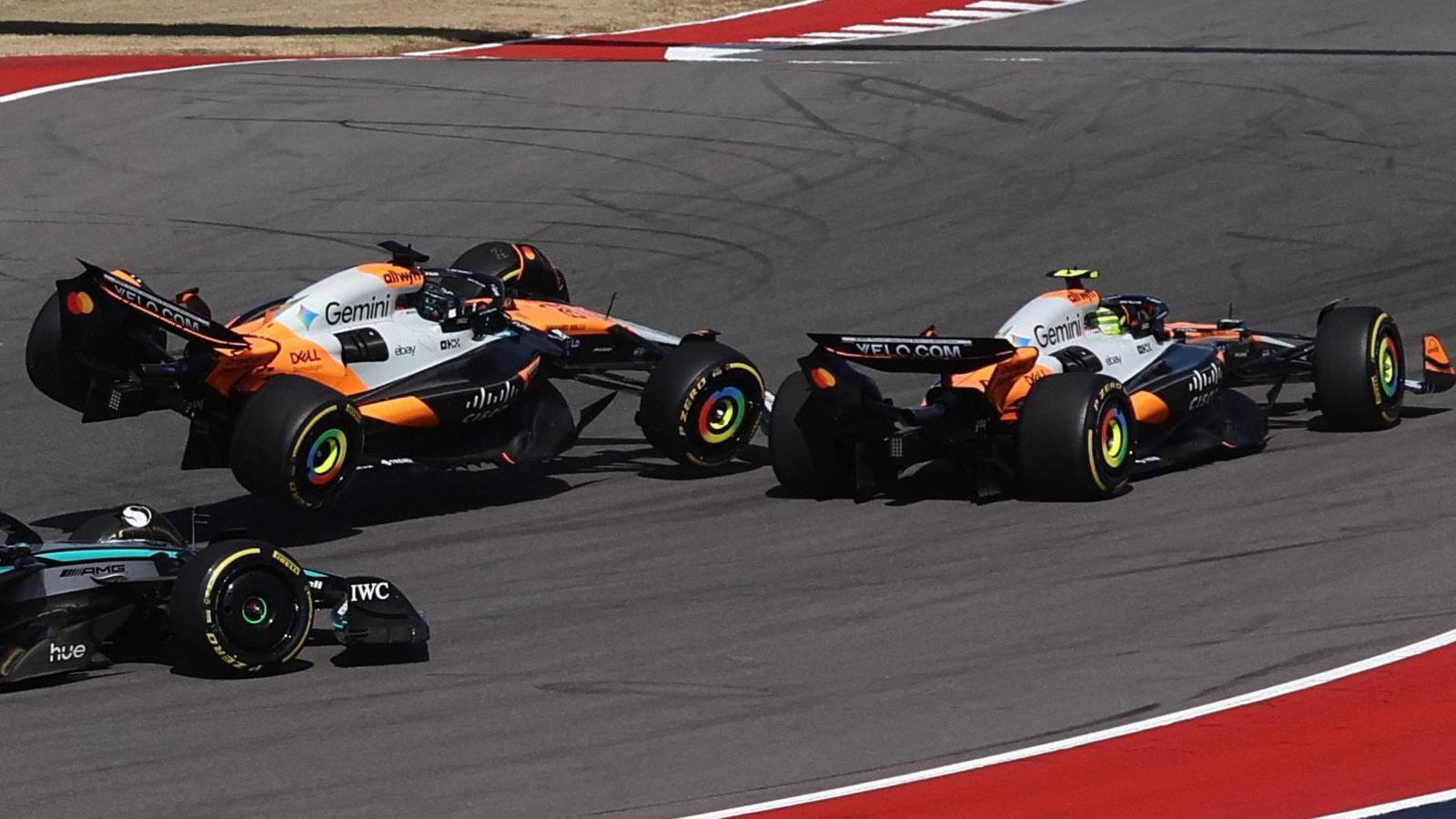 The McLarens of Lando Norris and Oscar Piastri collide at the first corner of the United States Grand Prix sprint race