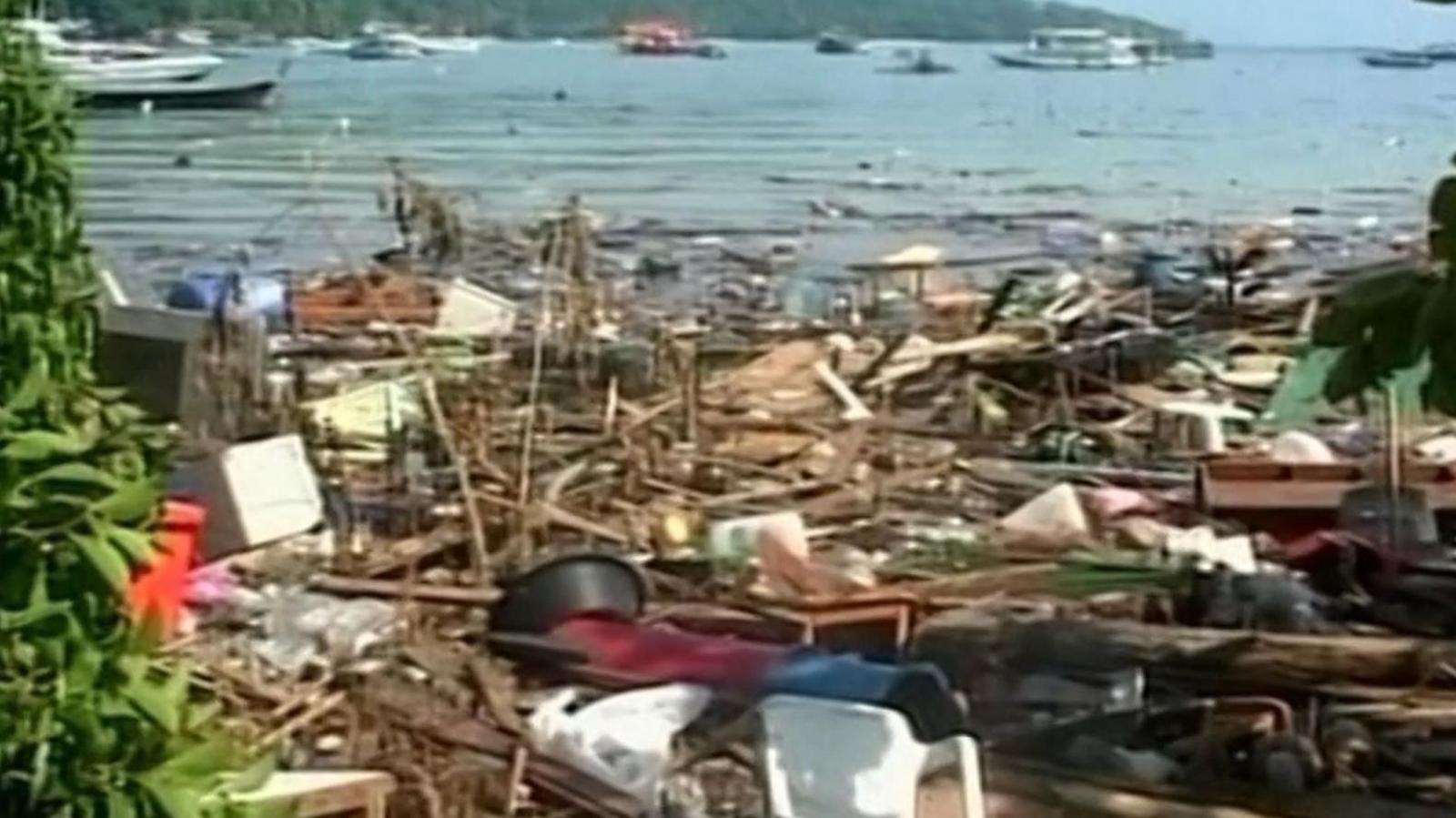 Wrecked harbour area, debris everywhere