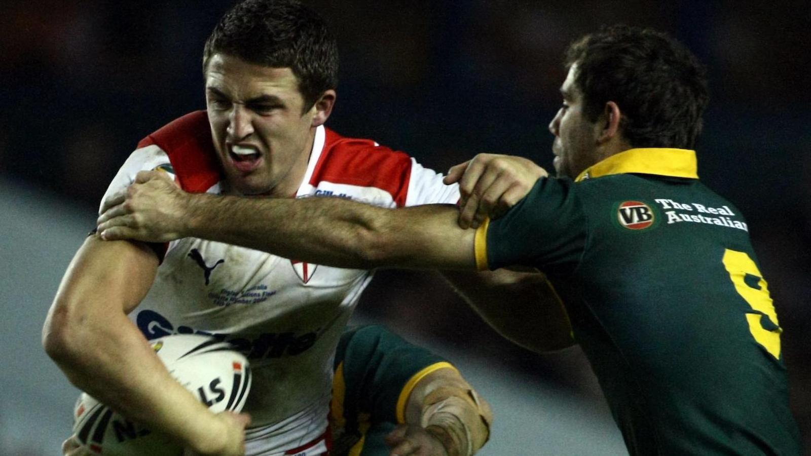 Sam Burgess tries to fend off Australia hooker Cameron Smith while playing for England in a Test match at Elland Road in Leeds