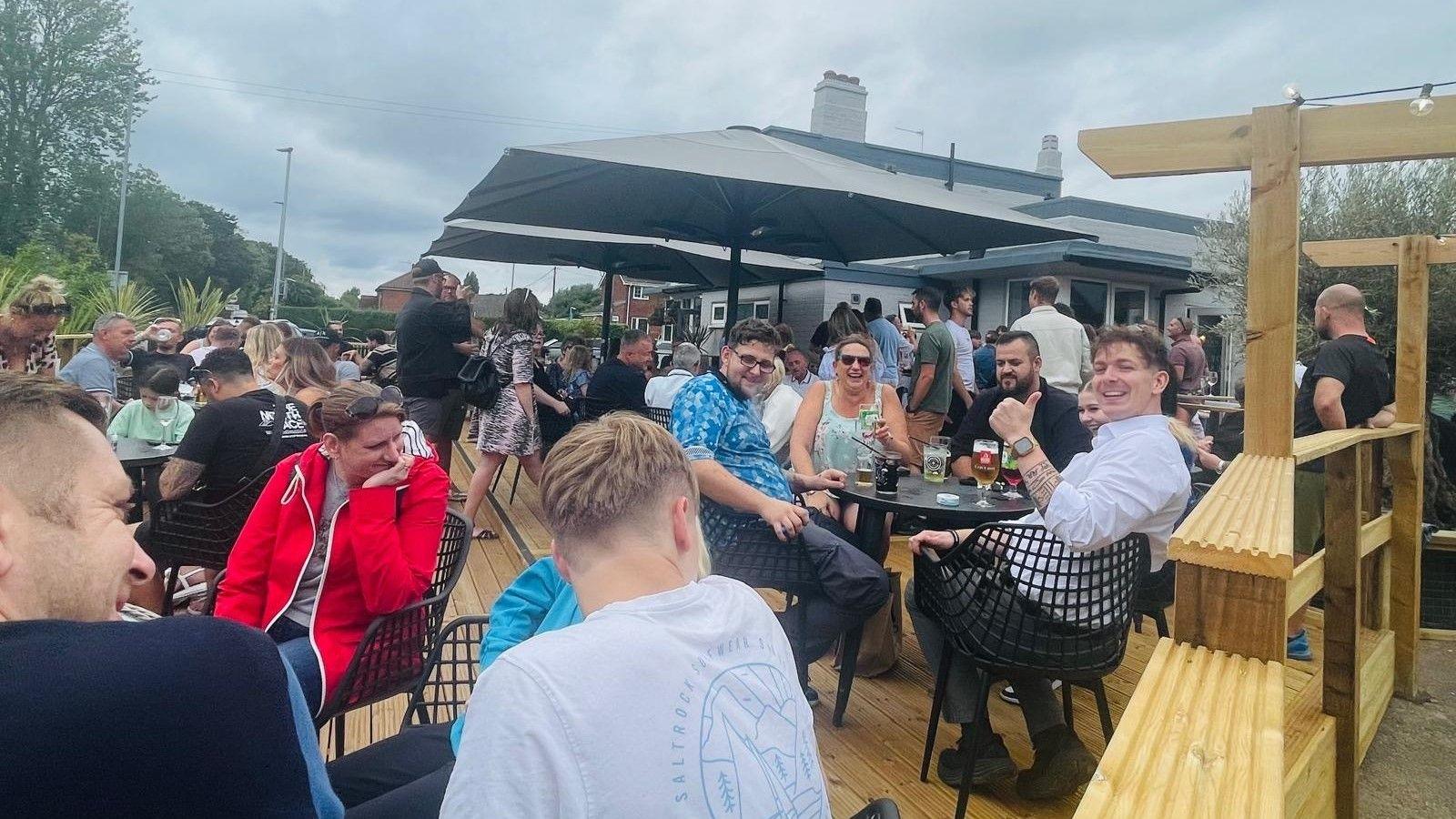 Customers enjoy the new beer garden of the reopened Sole and Heel pub in Rackheath