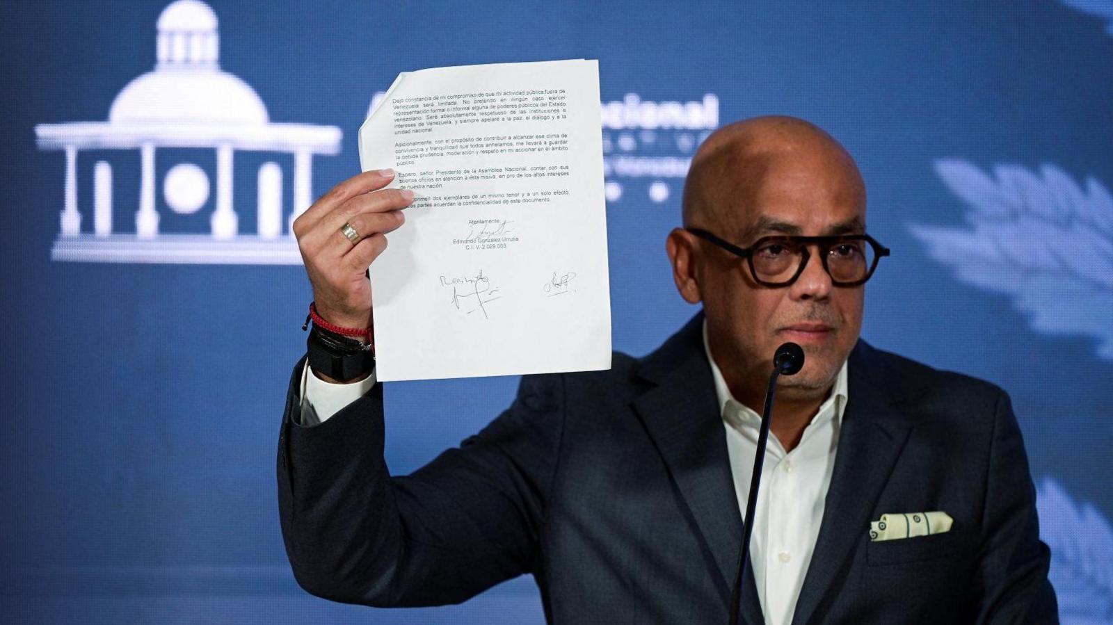 Venezuela's National Assembly Jorge Rodríguez presents what he says is the letter signed by González of his own volition