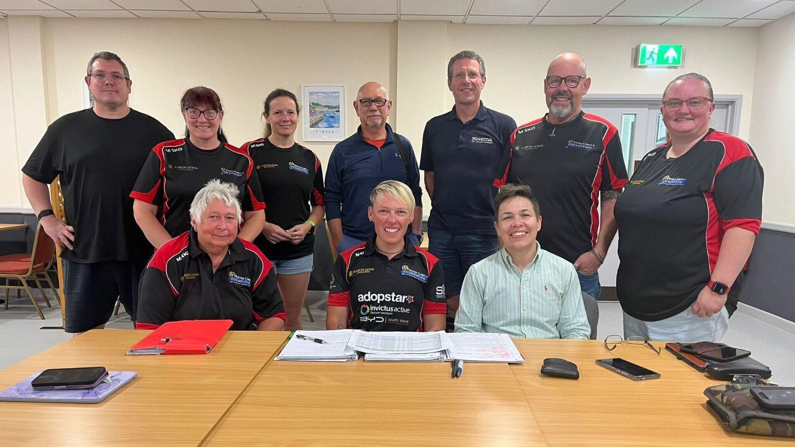 Lexi Chambers sat in the centre of the table with her team of supporters around her