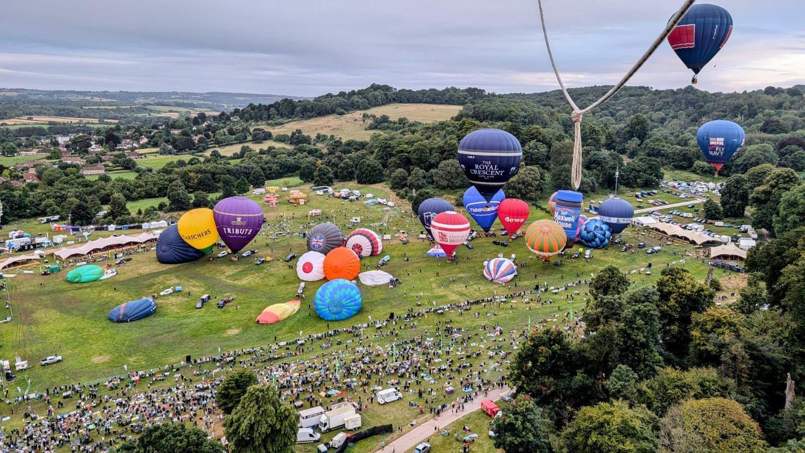 Hot air balloons on the ground at the Bristol Balloon Fiesta, seen from the air