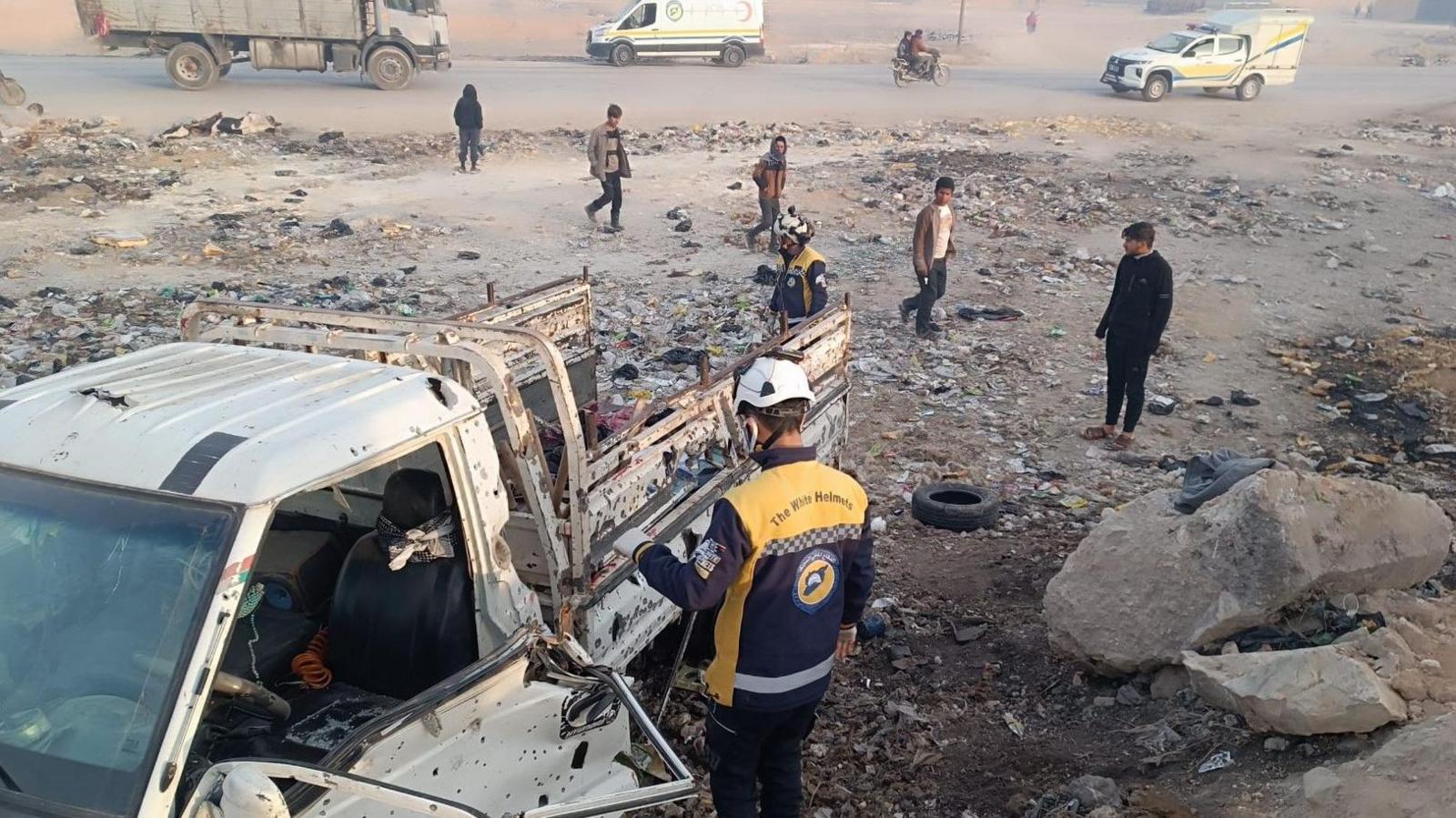 White Helmets first responders from the Syria Civil Defence inspect a bomb-damaged van in Manbij, northern Syria (3 February 2025)