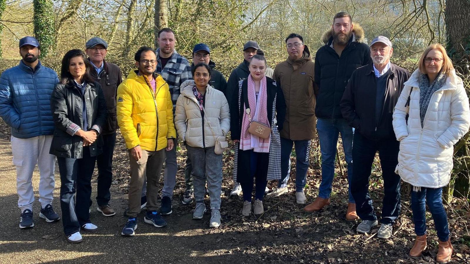 A picture of thirteen residents stood on a path in front of land where a recycling centre could be built in Milton Keynes.