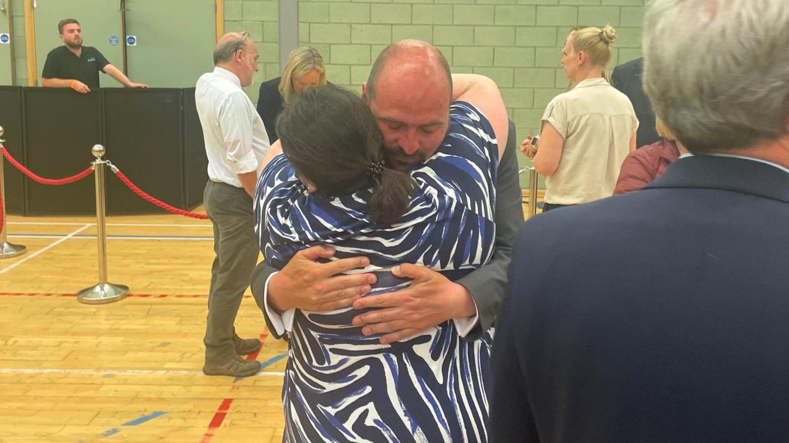 Richard Holden hugs a person