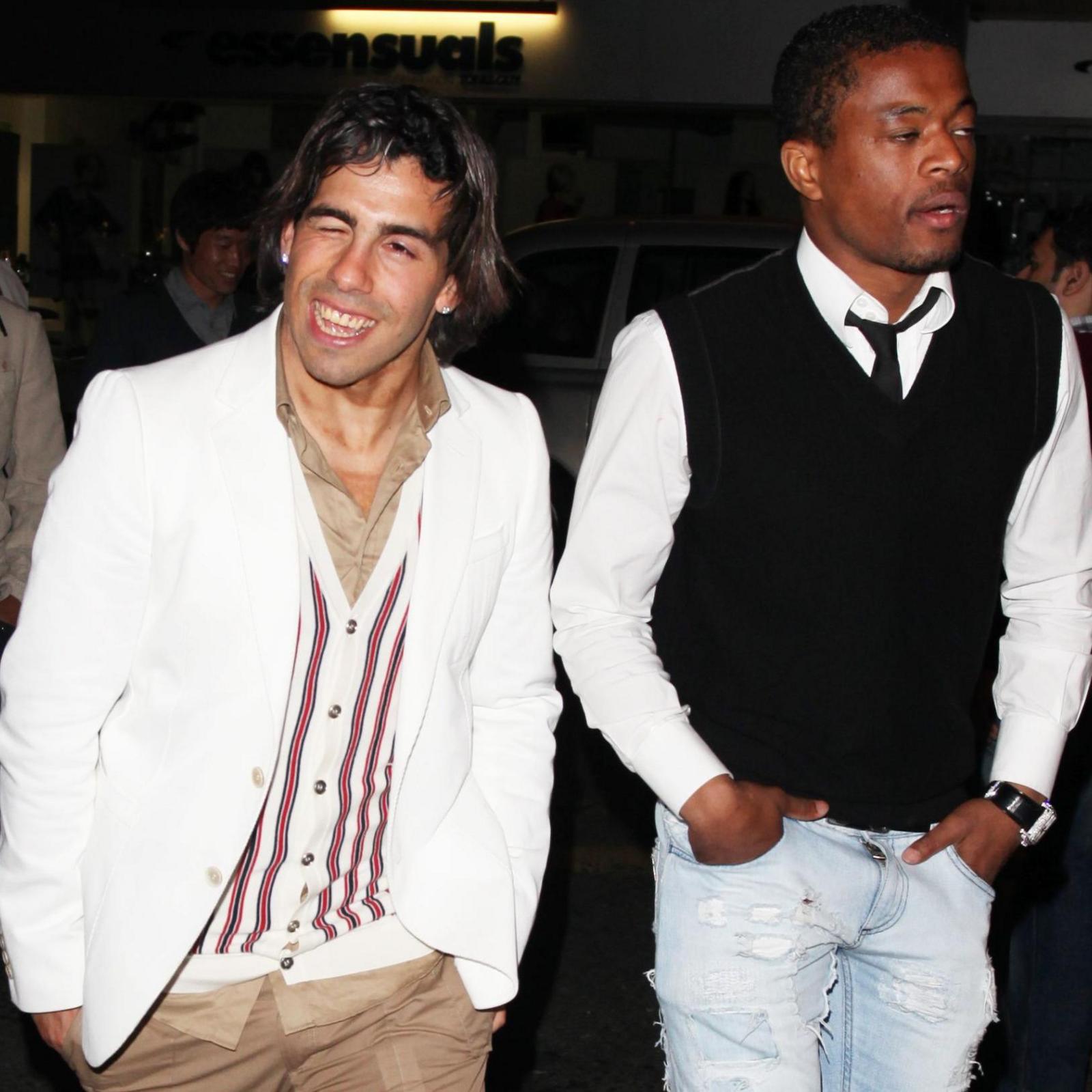 Carlos Tevez and Patrice Evra walk in the street