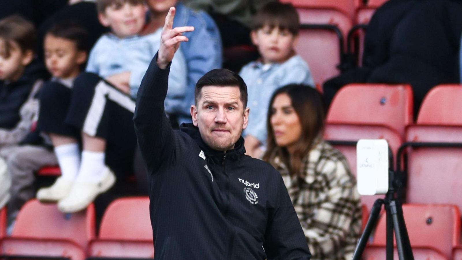Crewe Alexandra boss Lee Bell points instructions to his players during a match