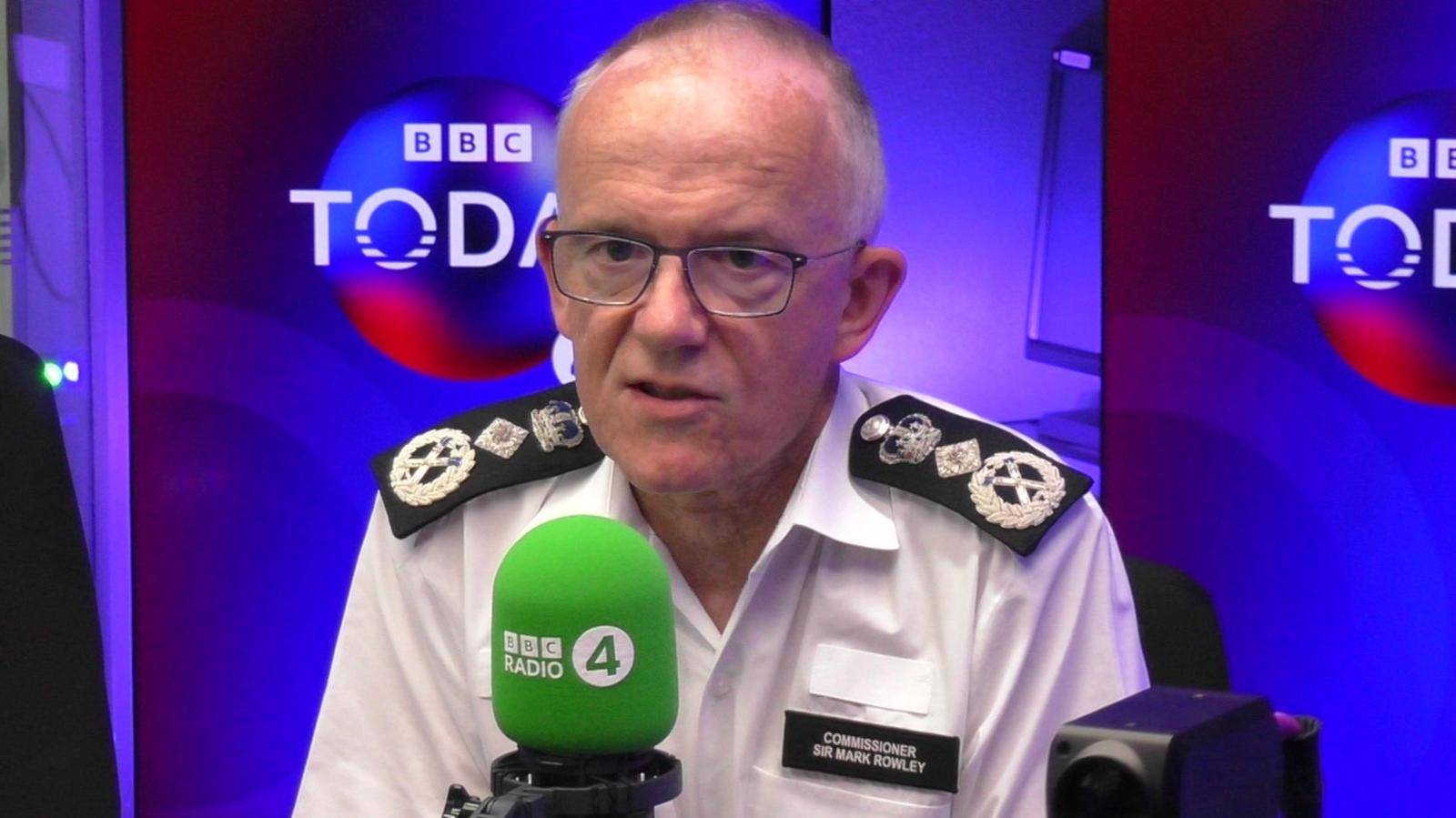 Sir Mark Rowley speaks into a green mic in the BBC Radio 4 studio