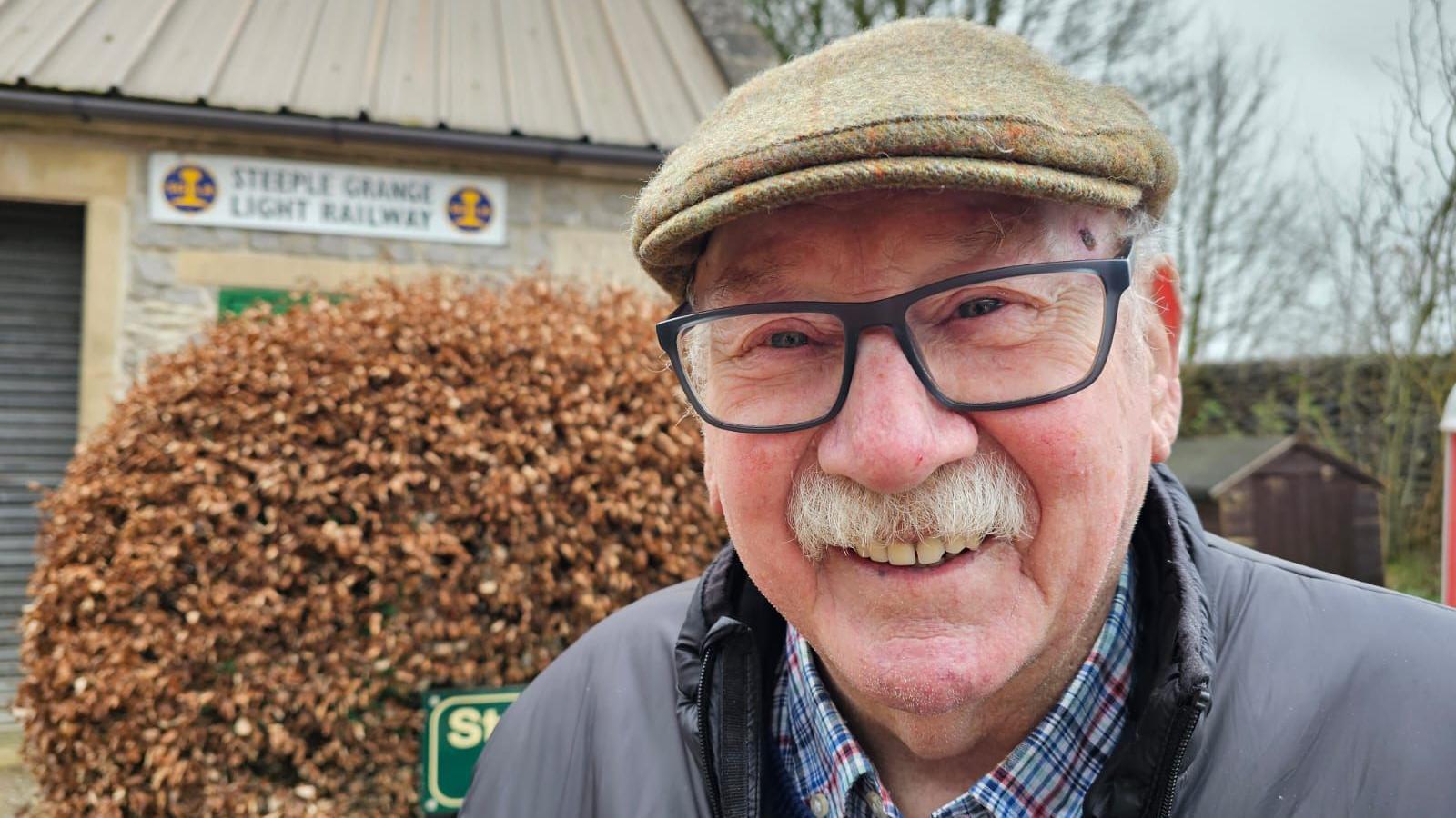 Jim Goldsmith standing in front of the depo at Steeple Grange Light Railway