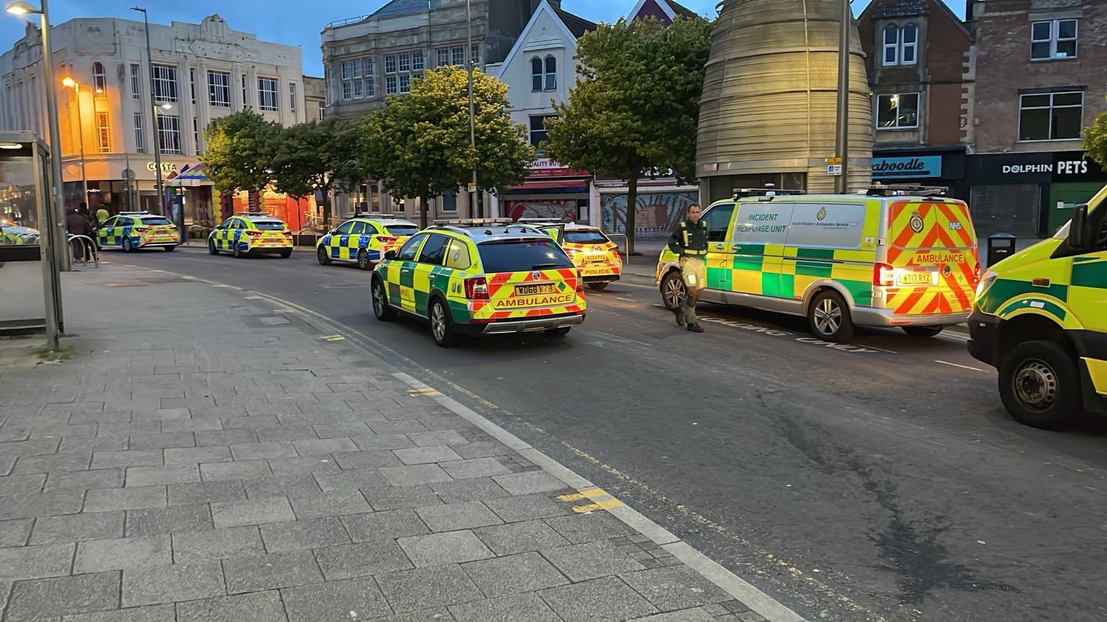 Ambulance and police cars block road 