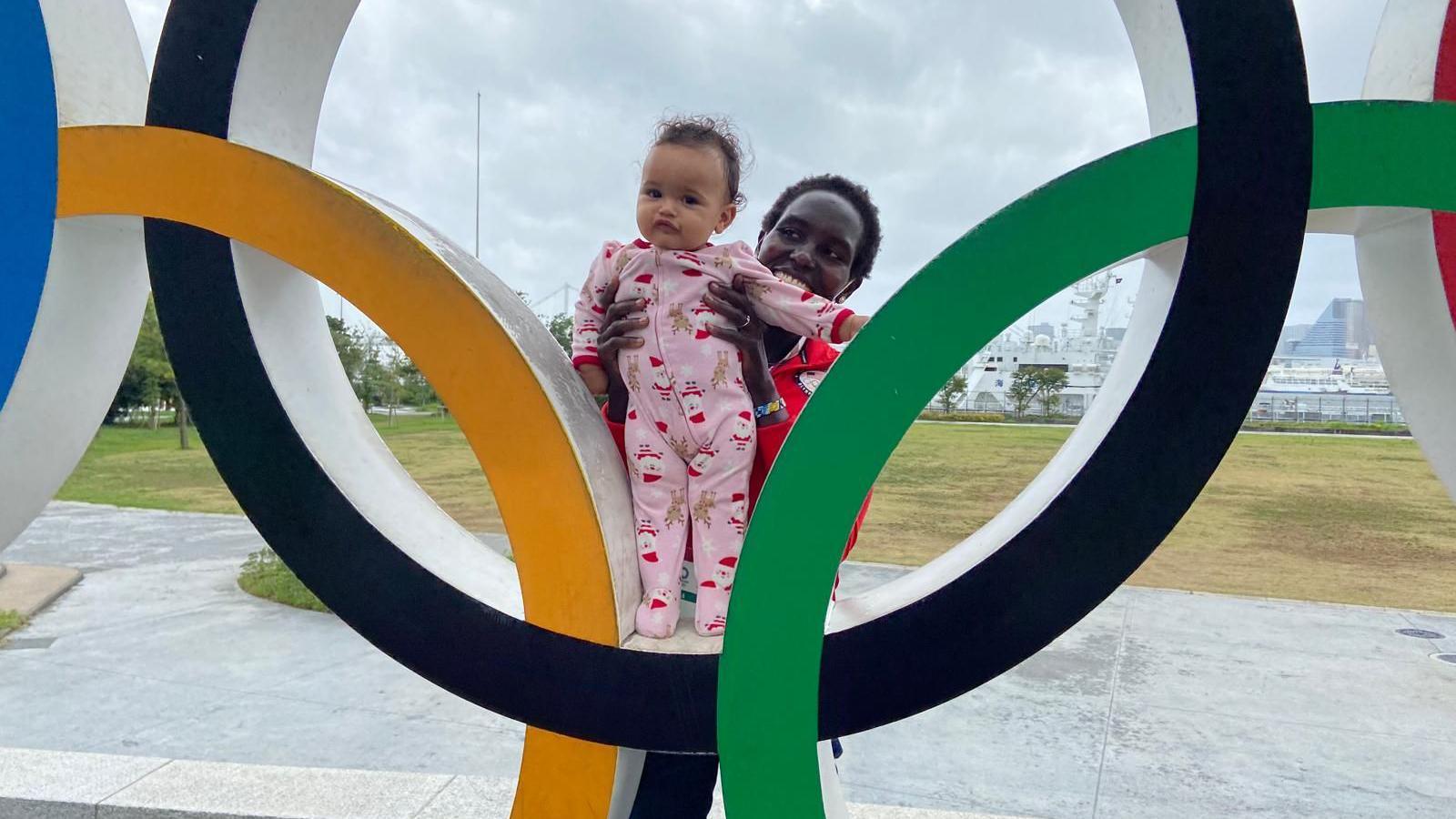 Kenya-born American marathon runner Aliphine Tuliamuk and her baby daughter Zoe at a park in Tokyo in 2021