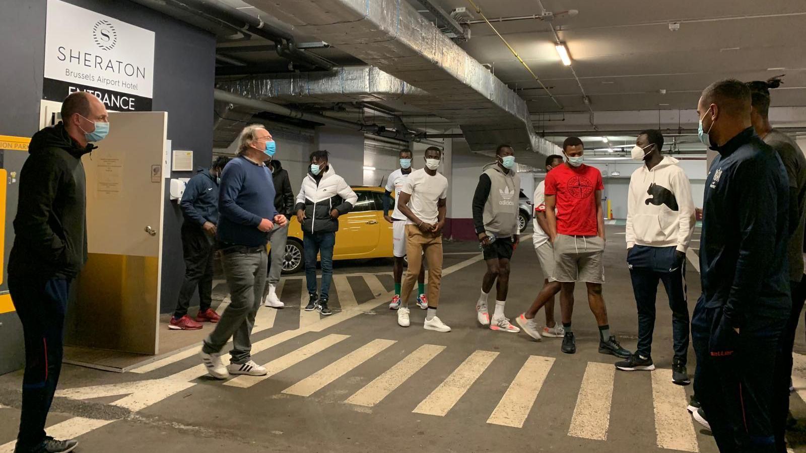 Gambia football manager Tom Saintfiet and some of his players have an impromptu training session in a car park at Brussels Airport without proper training gear