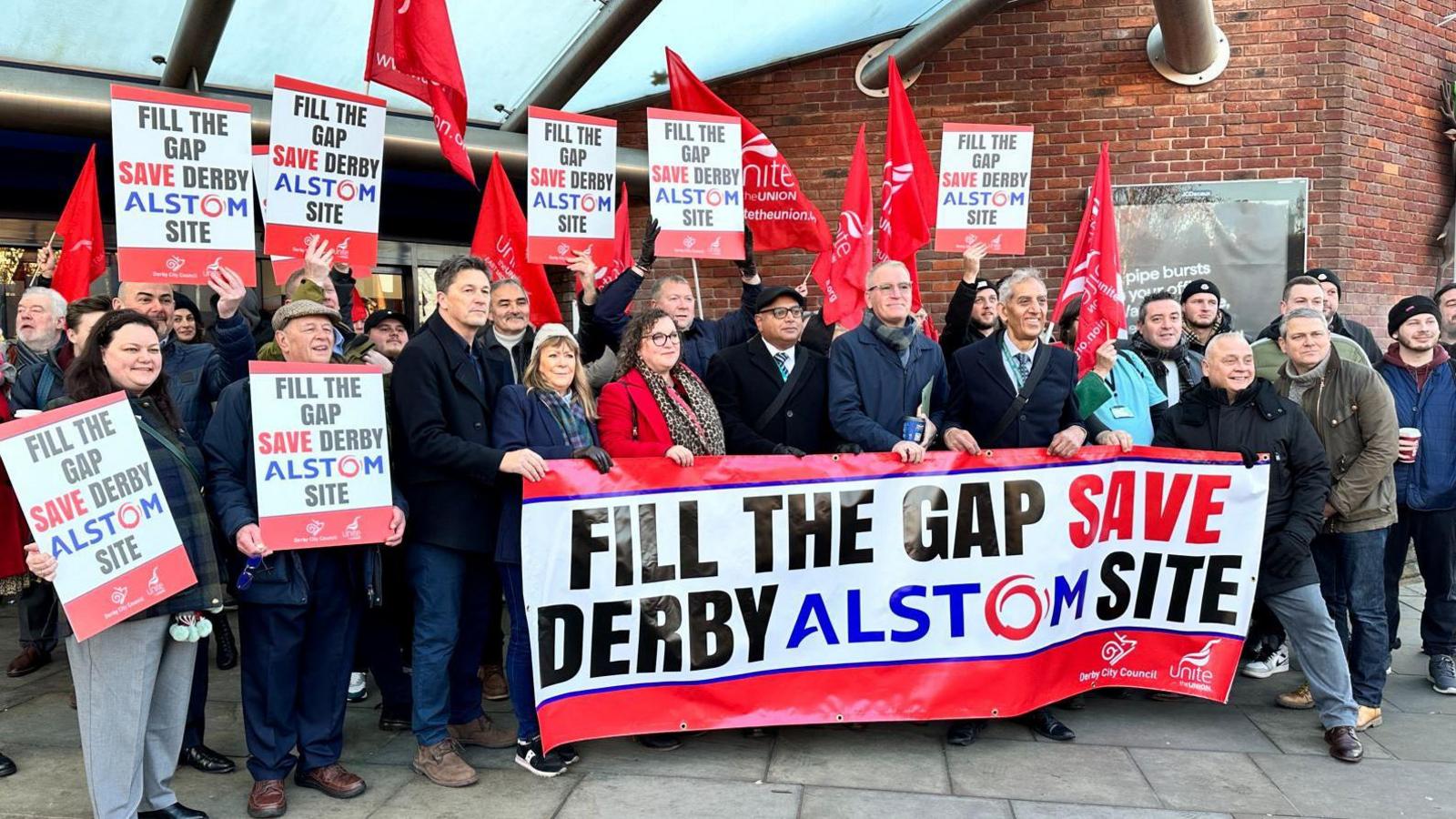 Workers, unions and politicians outside Derby railway station