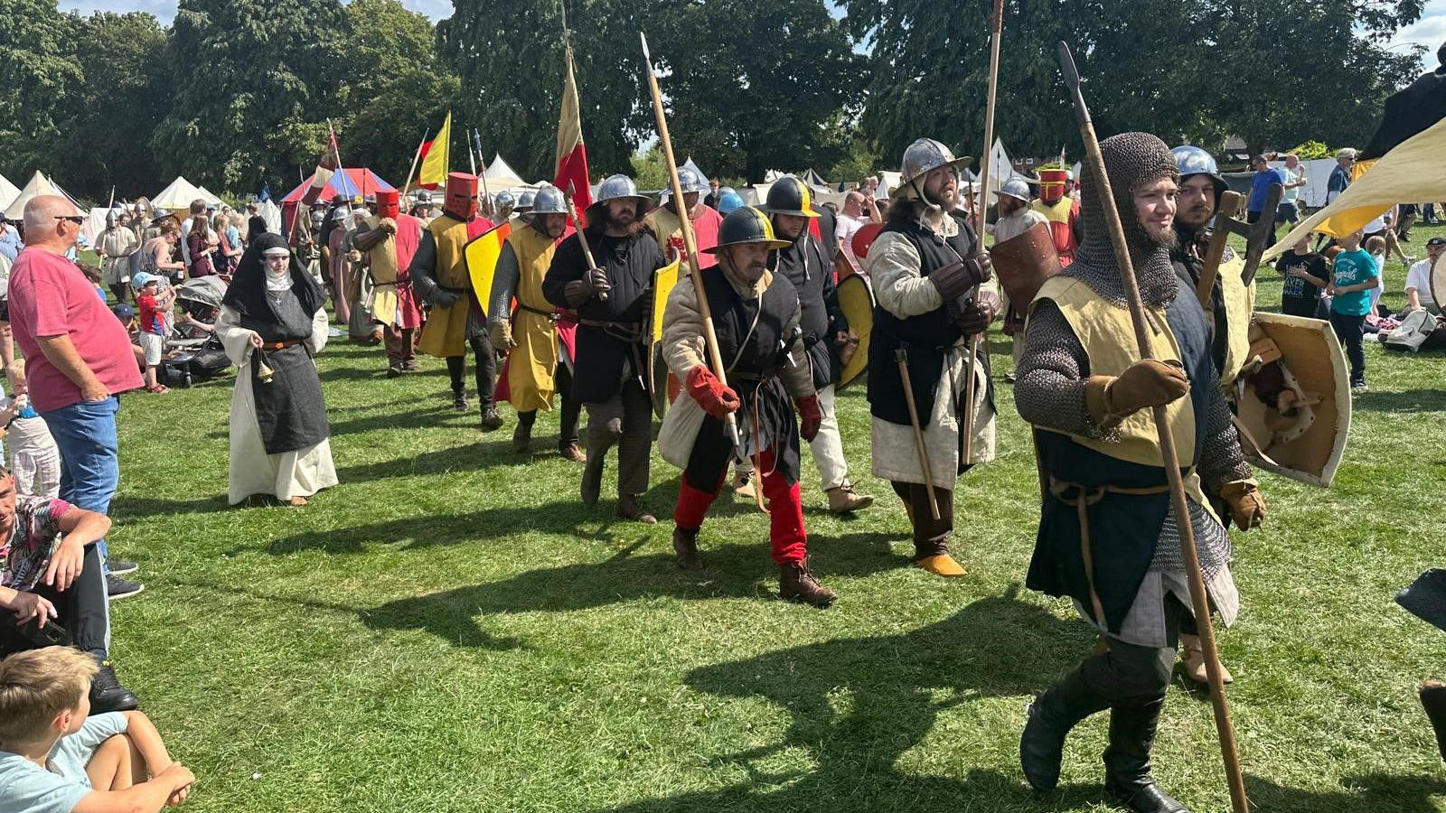 Medieval re-enactors marching at Evesham