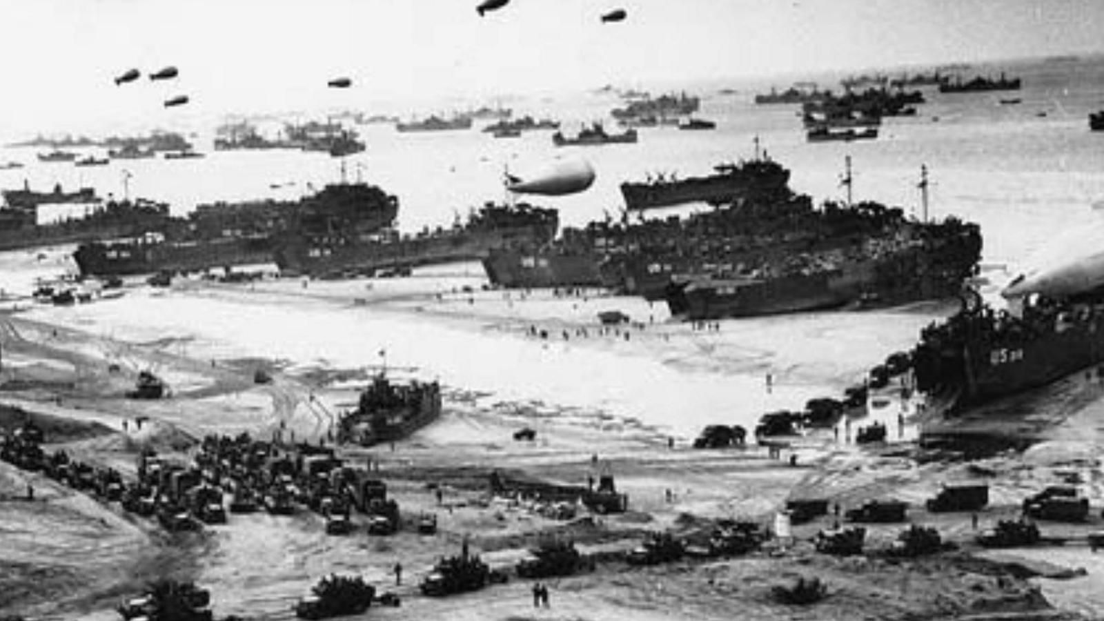 Soldiers in cargo vehicles moving onto a beach during the Allied Invasion of Europe, D-Day, in Normandy, France, 6th June 1944