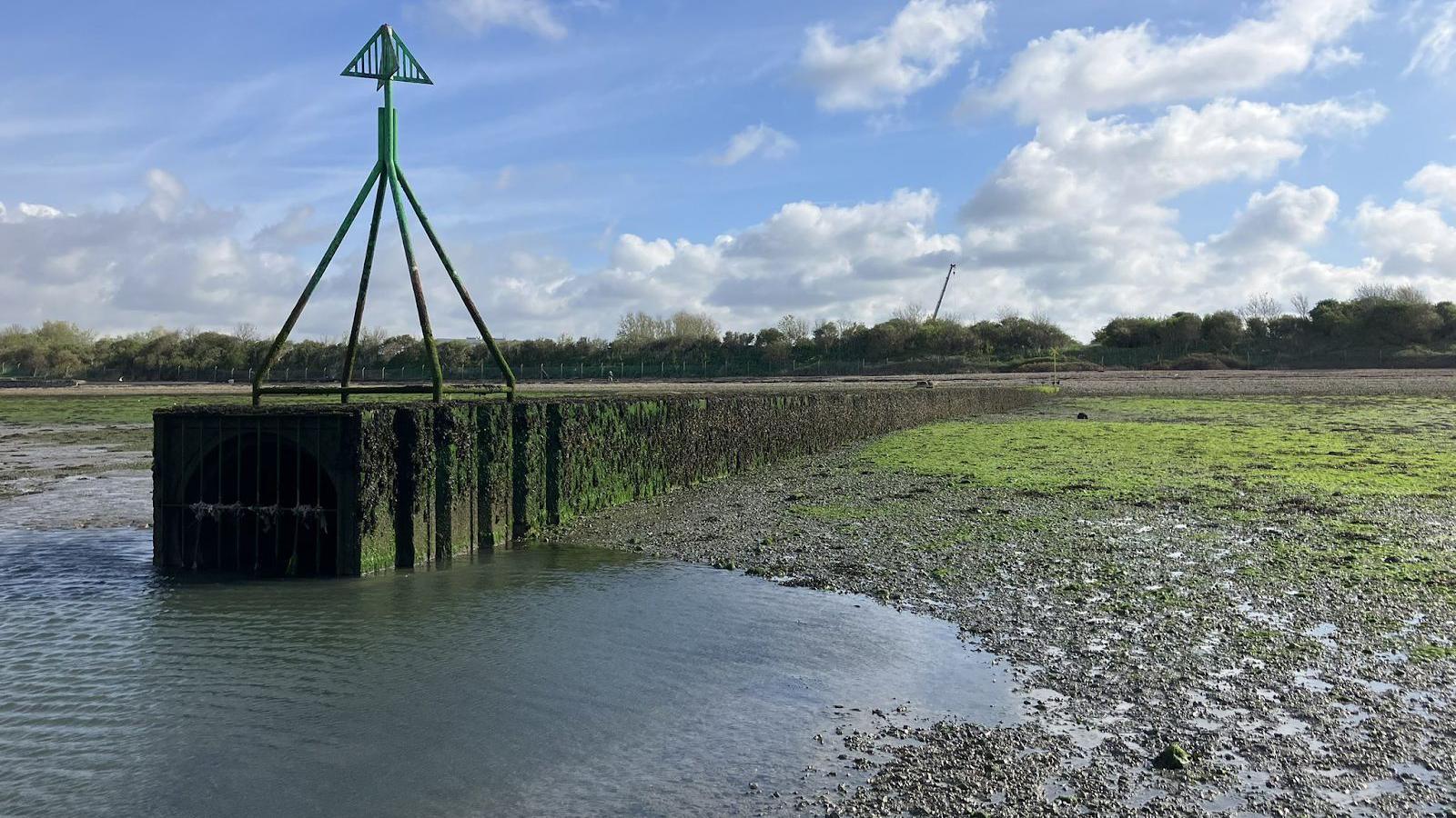 A pipe at Budds Farm, a sewage treatment plant, extending into the water