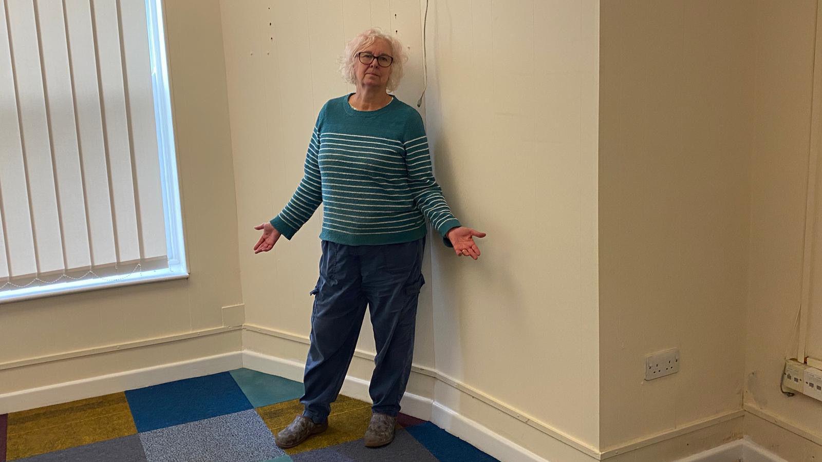 Chris Sexton stood gesturing in the empty sorting room.