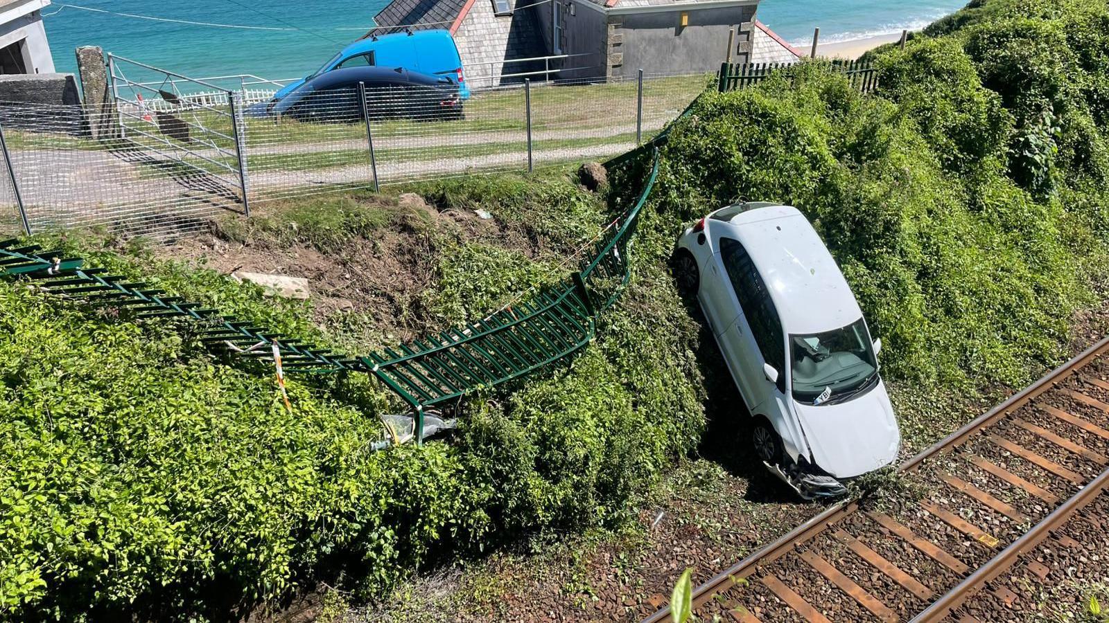 A car has blocked the Cornwall rail line after 'careering through fencing' onto the tracks; major disruption expected.