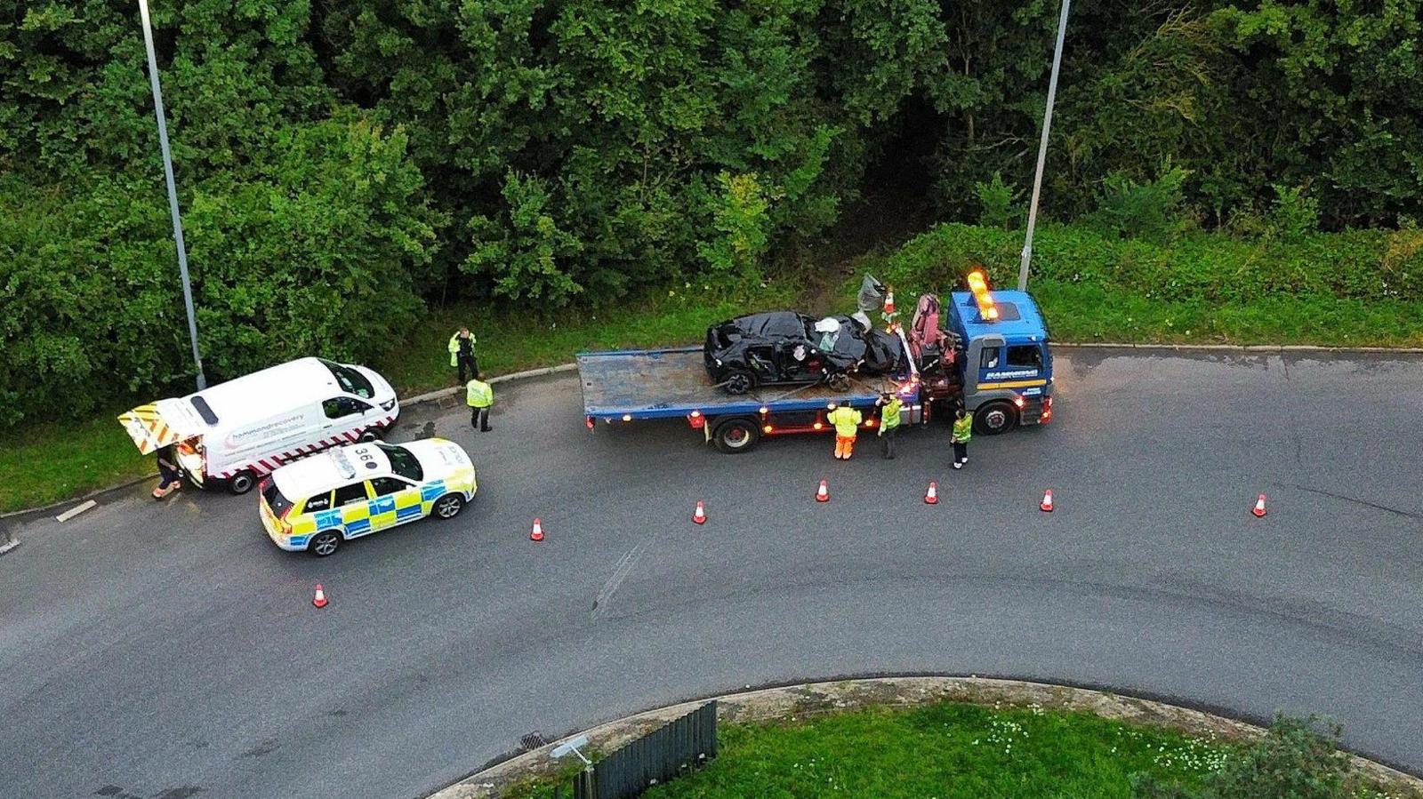 A drone shot of the car on a tow truck