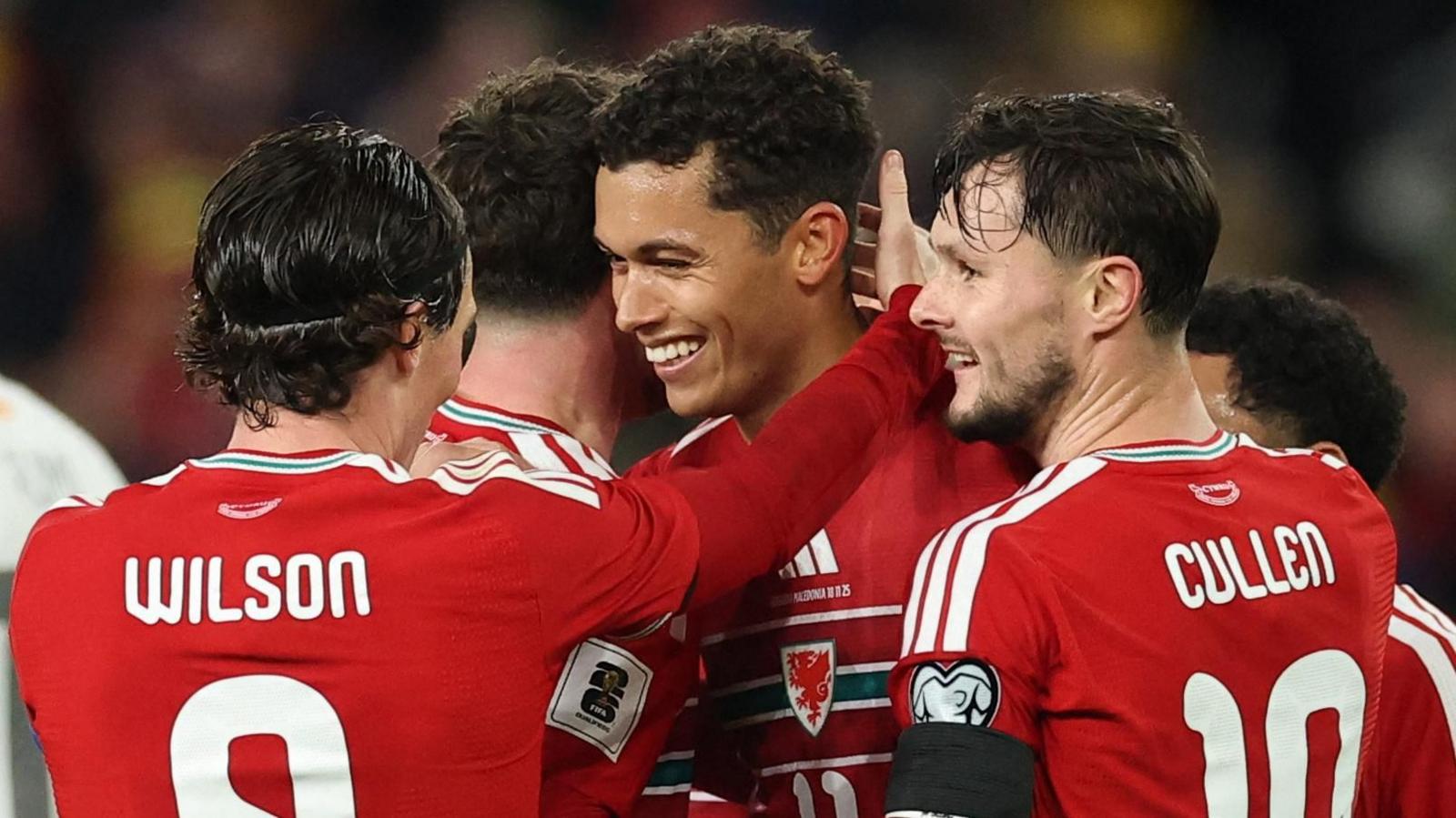 Liam Cullen (right) celebrates with Wales team-mates against North Macedonia