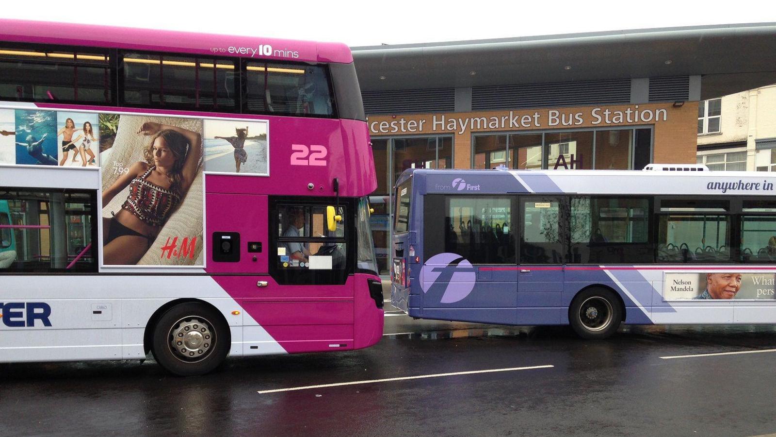 Two buses driving near to Leicester's Haymarket Bus Station in the centre of the city