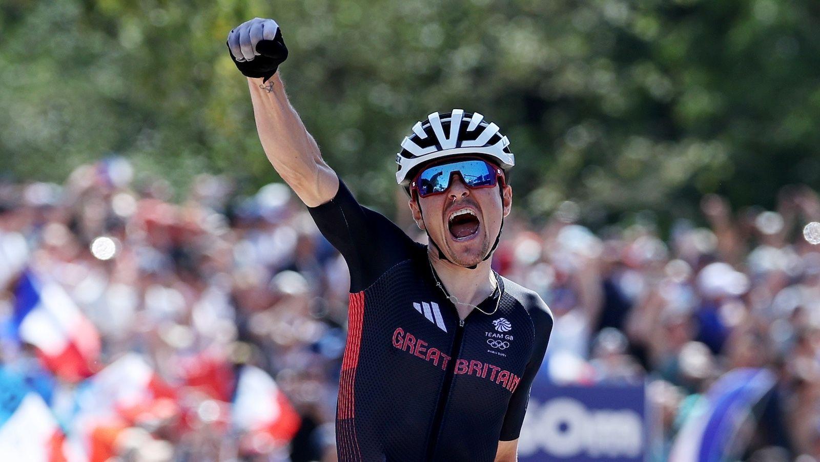 Tom Pidcock celebrates as he crosses the finish line