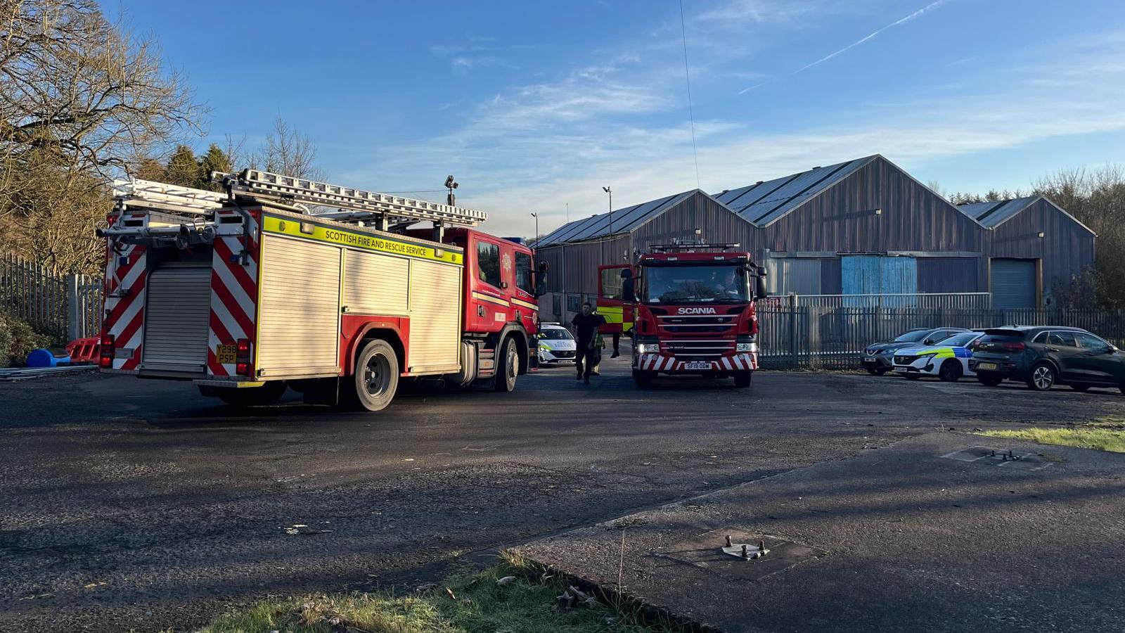 Two fire engines parked in front of the Sapphire Mill in Leslie, Fife. Two other emergency vehicles can also be seen.