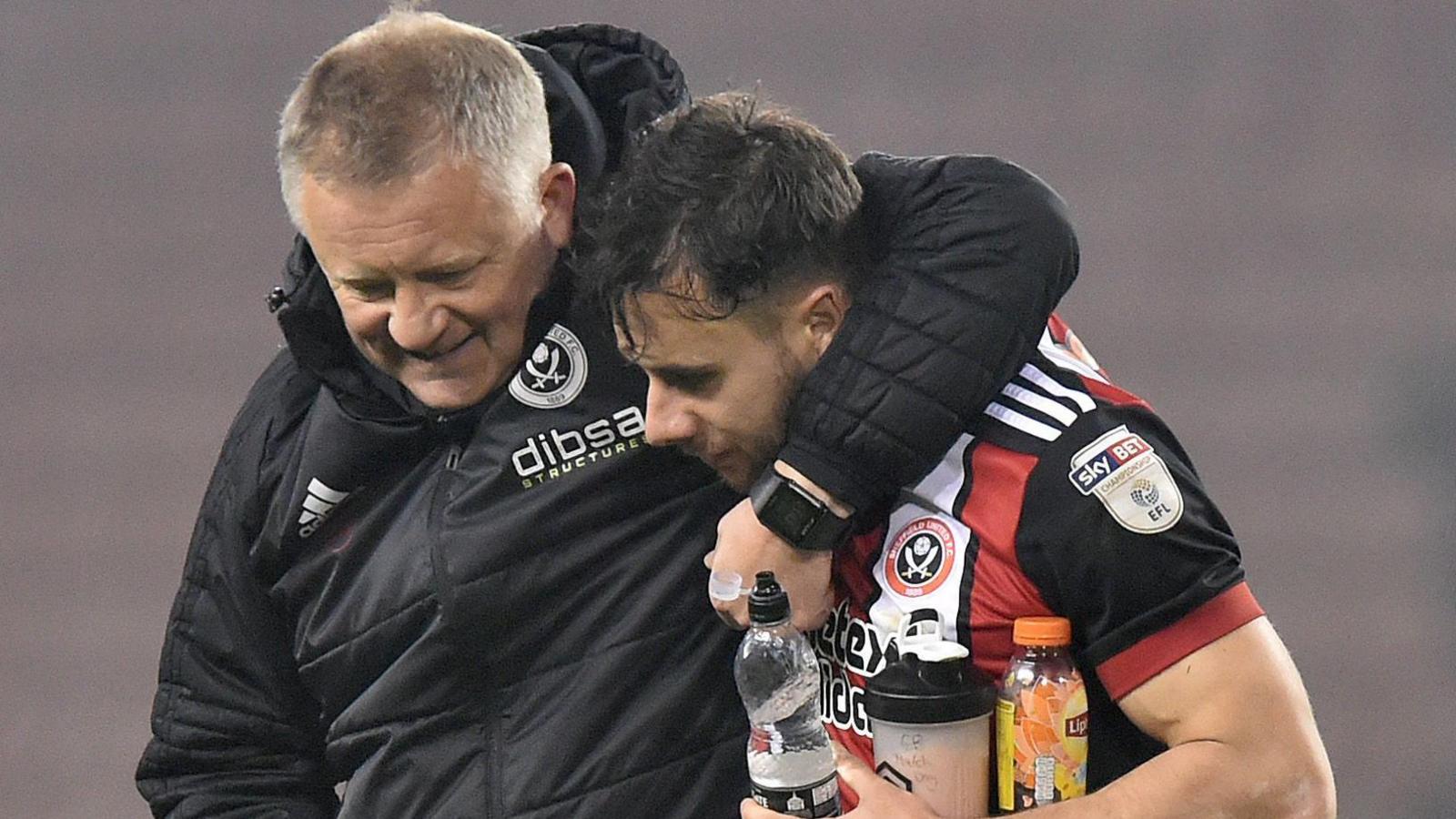 Chris Wilder has his arm around George Baldock after a Sheffield United game in April 2018