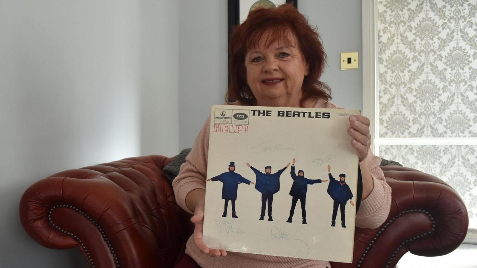 Annie Newby with the signed record of Help! by The Beatles