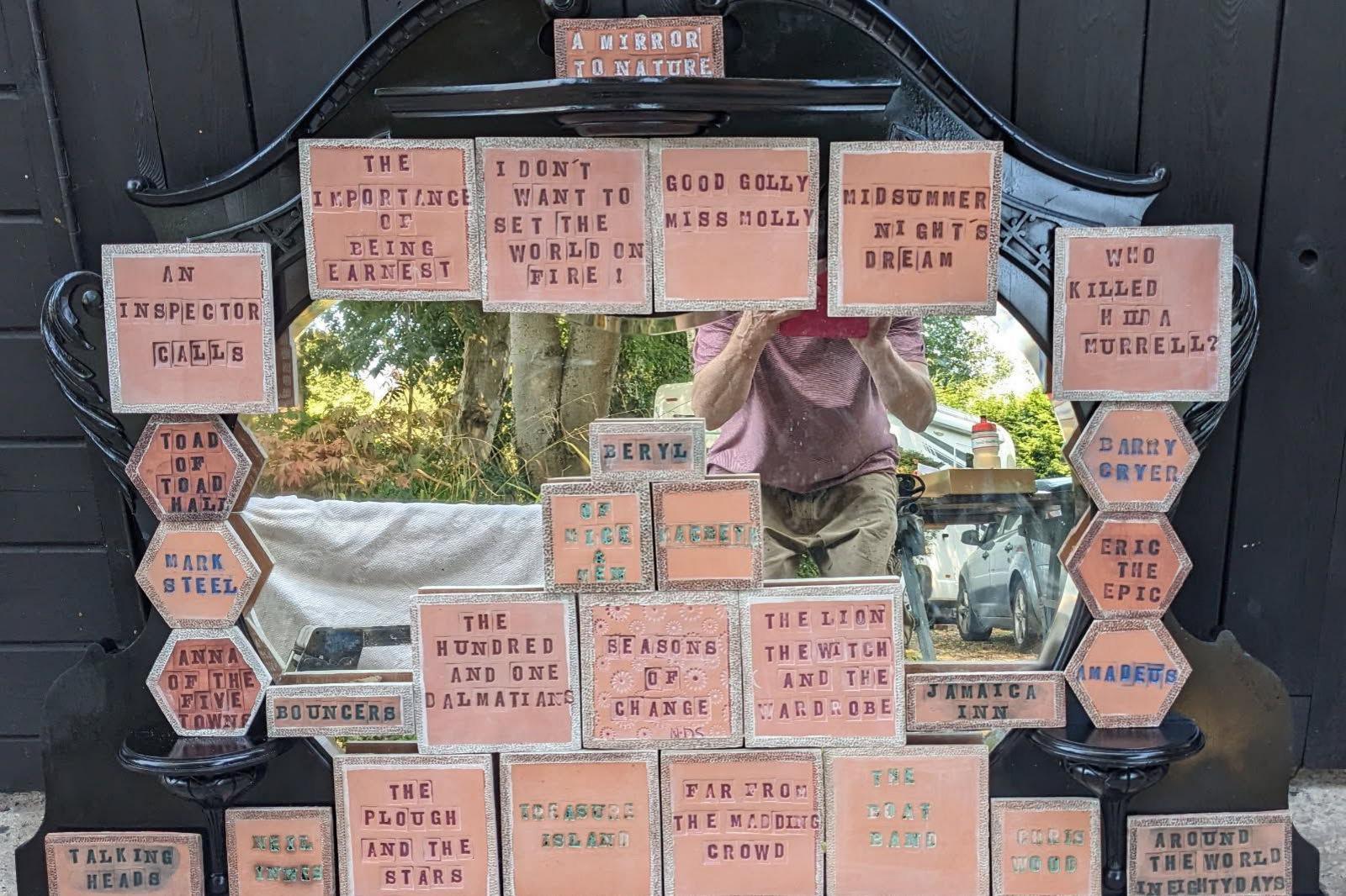 Ceramic tiles stamped with the names of theatre productions, including Far from the Madding Crowd, An Inspector Calls, Anne of the Five Towns, and The Importance of Being Earnest