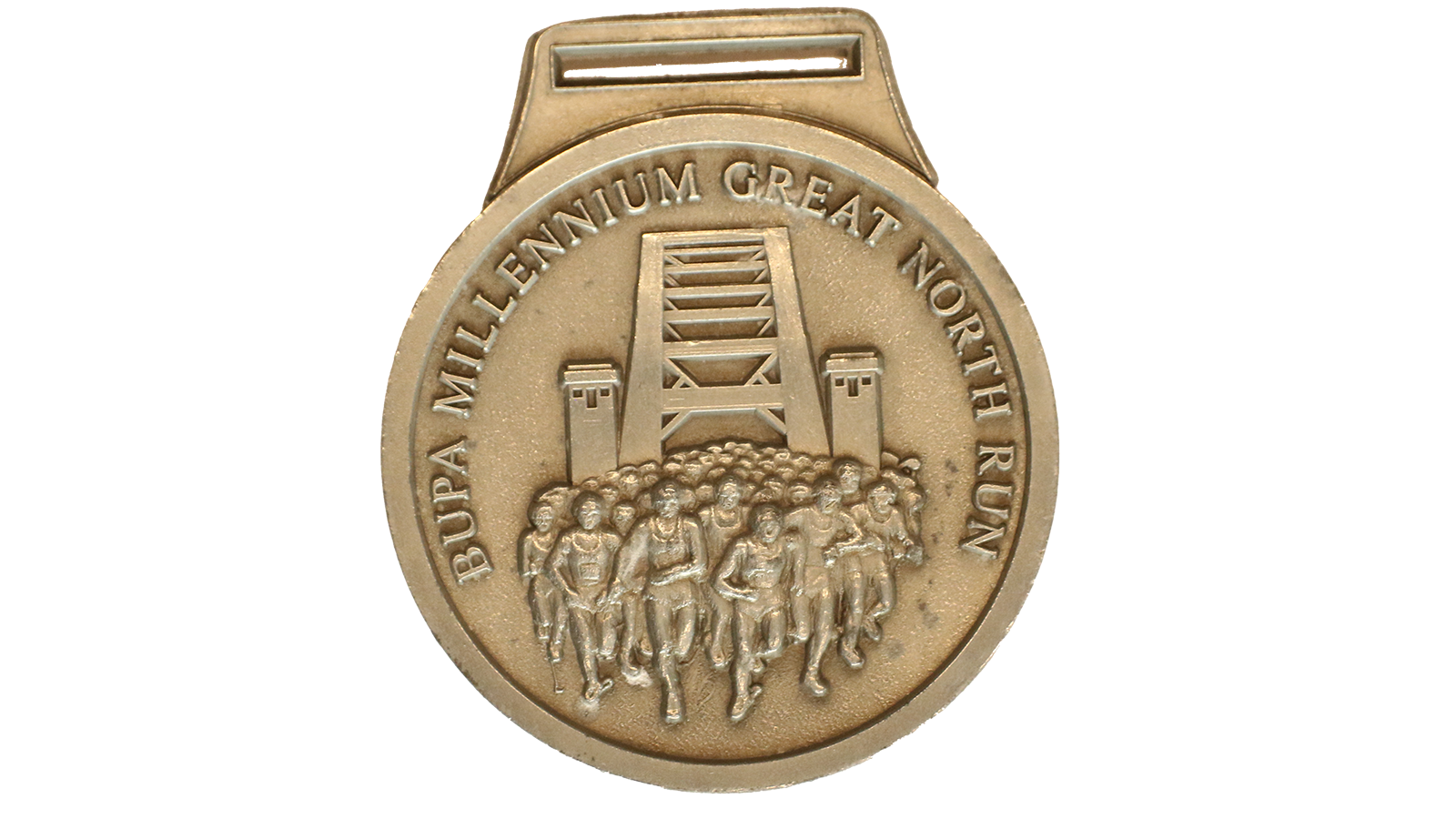 A circular light gold medal that reads around the side 'Bupa millennium great north run' it has a group of runners centre with the Tyne bridge in the background. 