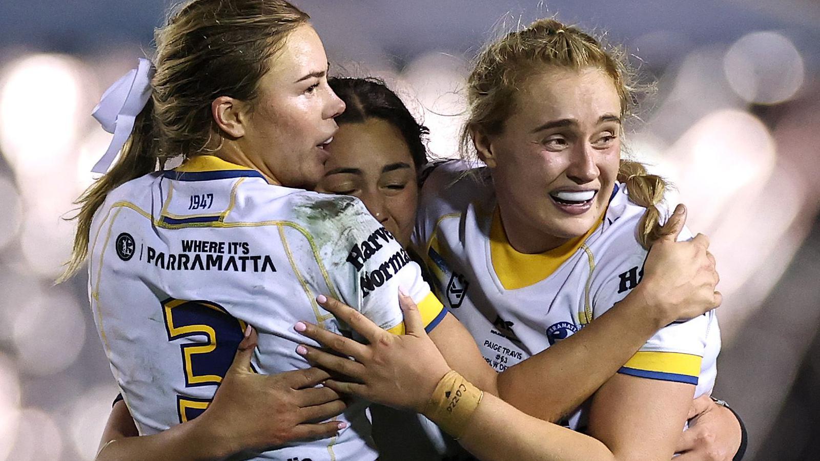 Paige Travis celebrates with Parramatta teammates, hugging after the 18-16 win over Cronulla in her first game.