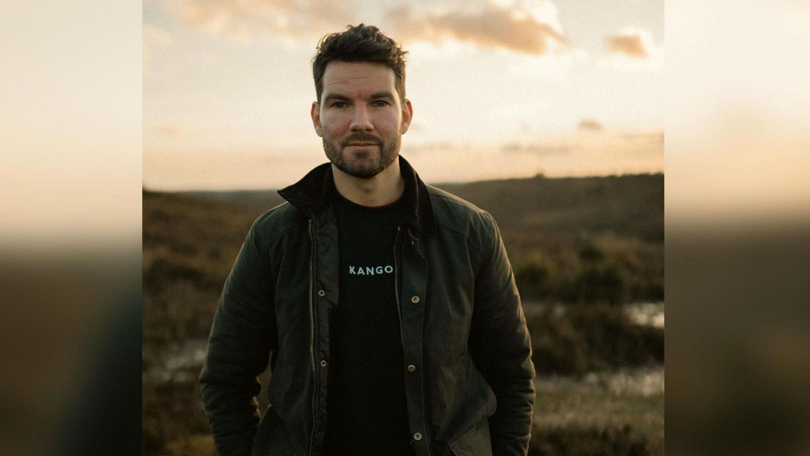 A photo of the film writer and director David Smith looking to camera with rural backdrop