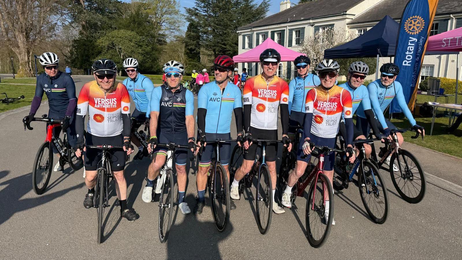 A group of road cyclists posing for a photograph