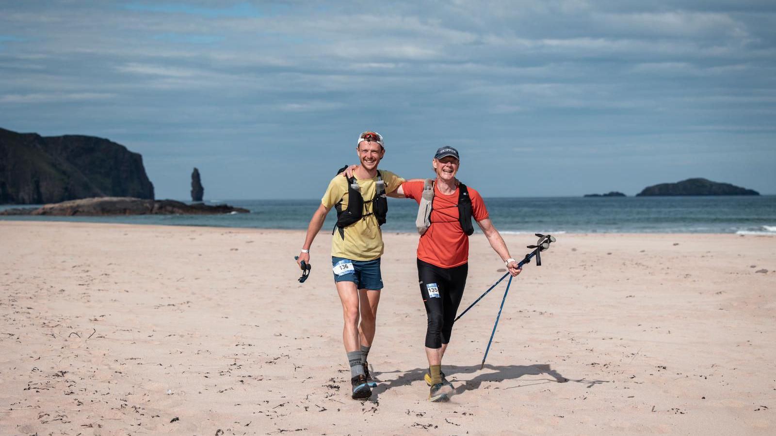 Will Robinson alongside his father Tim Robinson on a beach