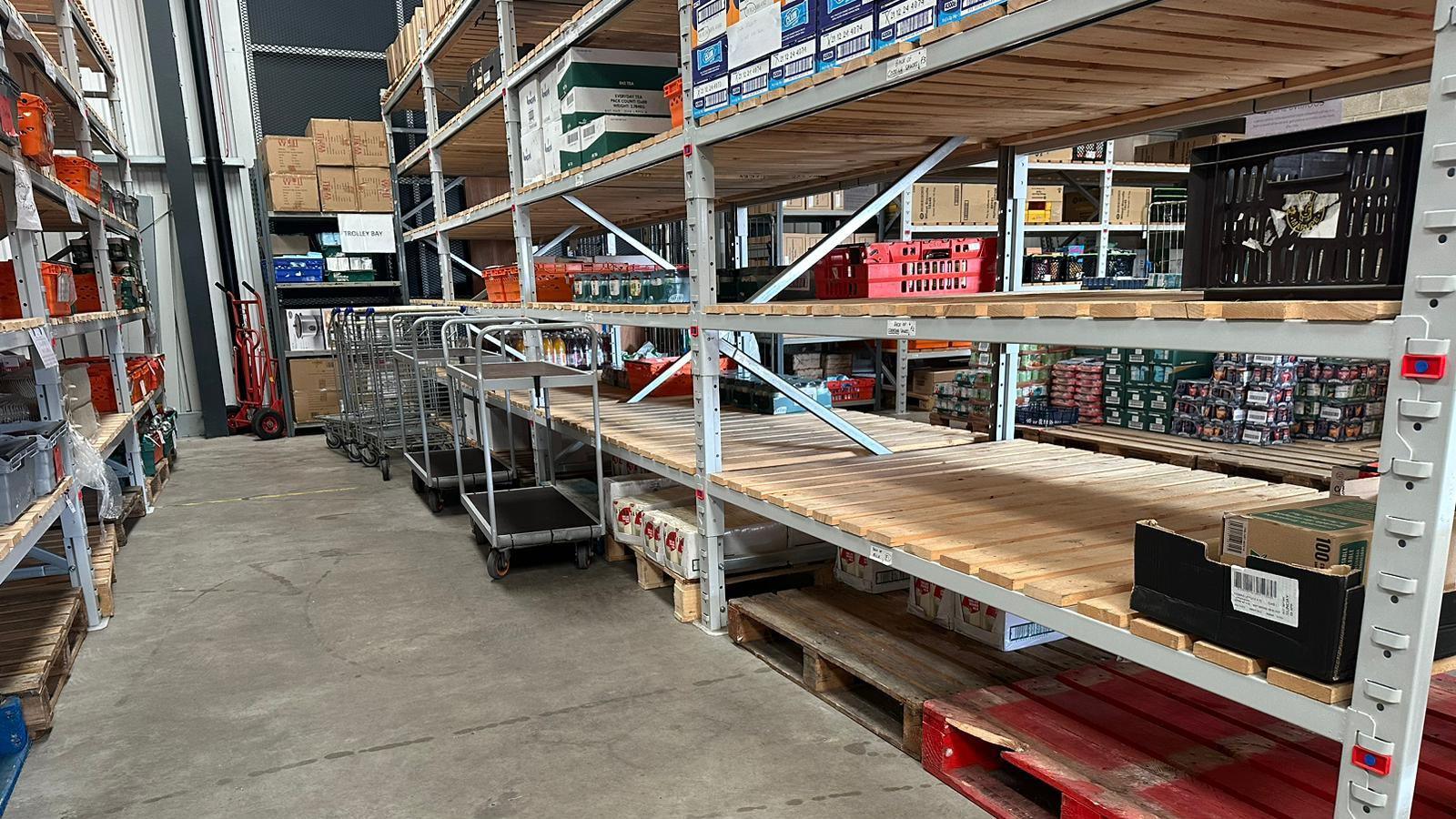 Bare shelves inside the warehouse used to store donations