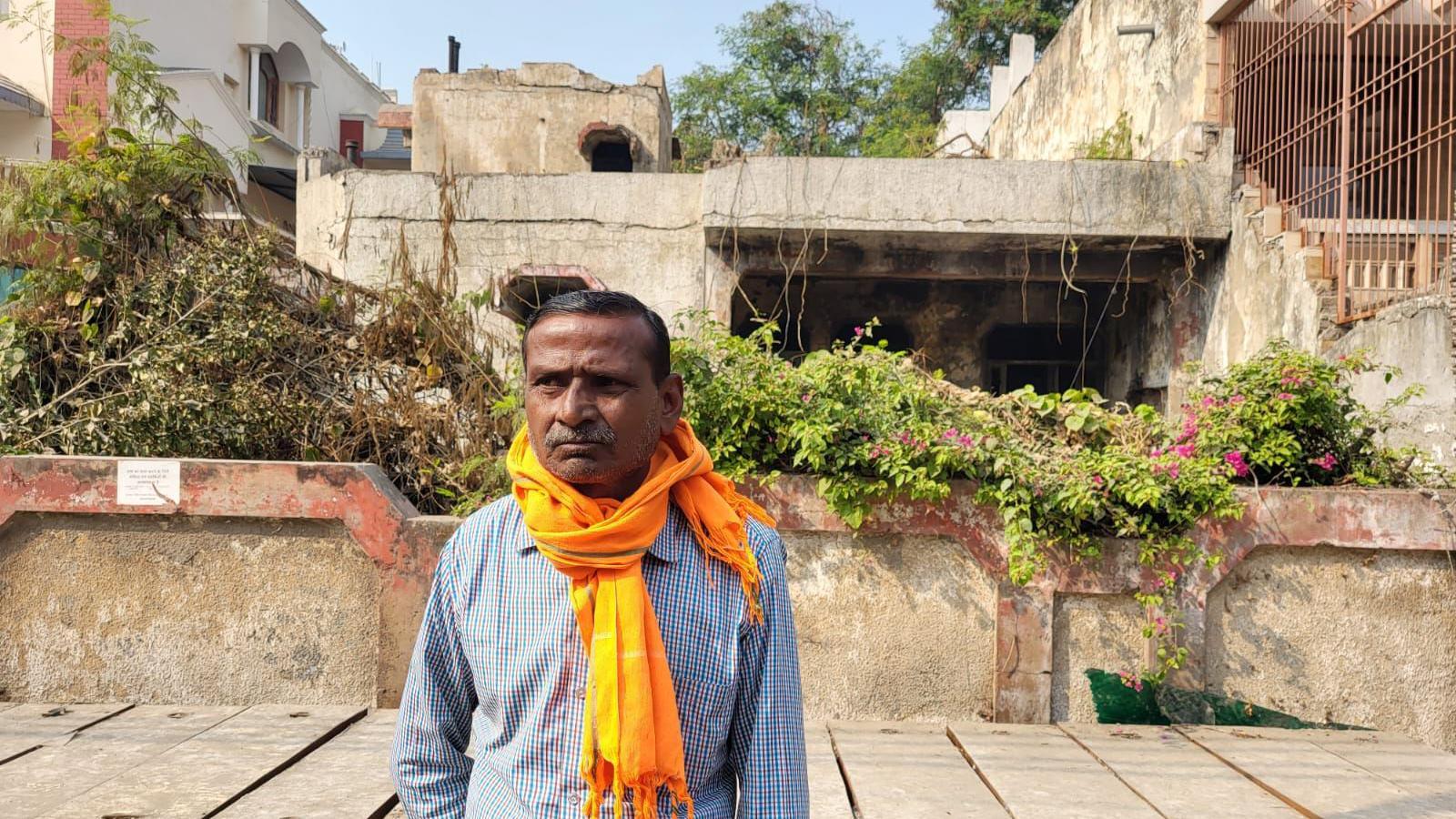 Pappu Lal stands outside bungalow D5 - the house where police said the crimes took place