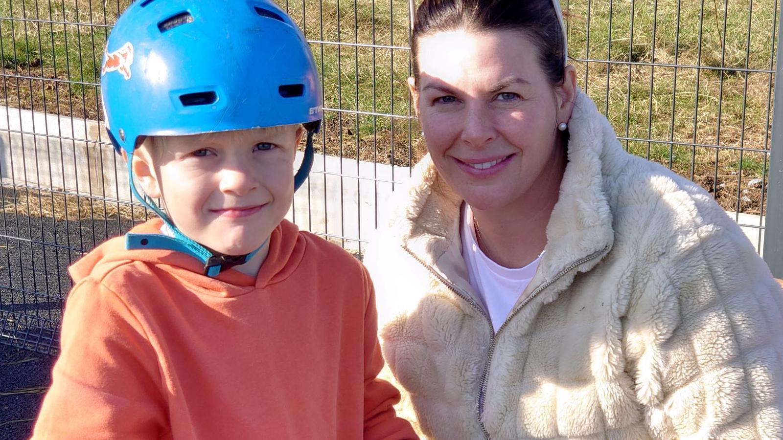 A mother and her young son using the new skate park facilities 