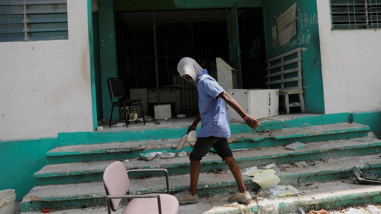 A man walks in front of a hospital that was looted by gangs in Port-au-Prince, Haiti. Photo: March 2024