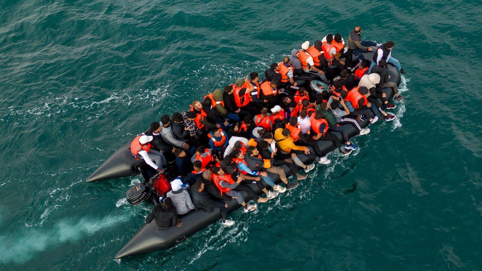 An inflatable boat full of people crossing the English Channel