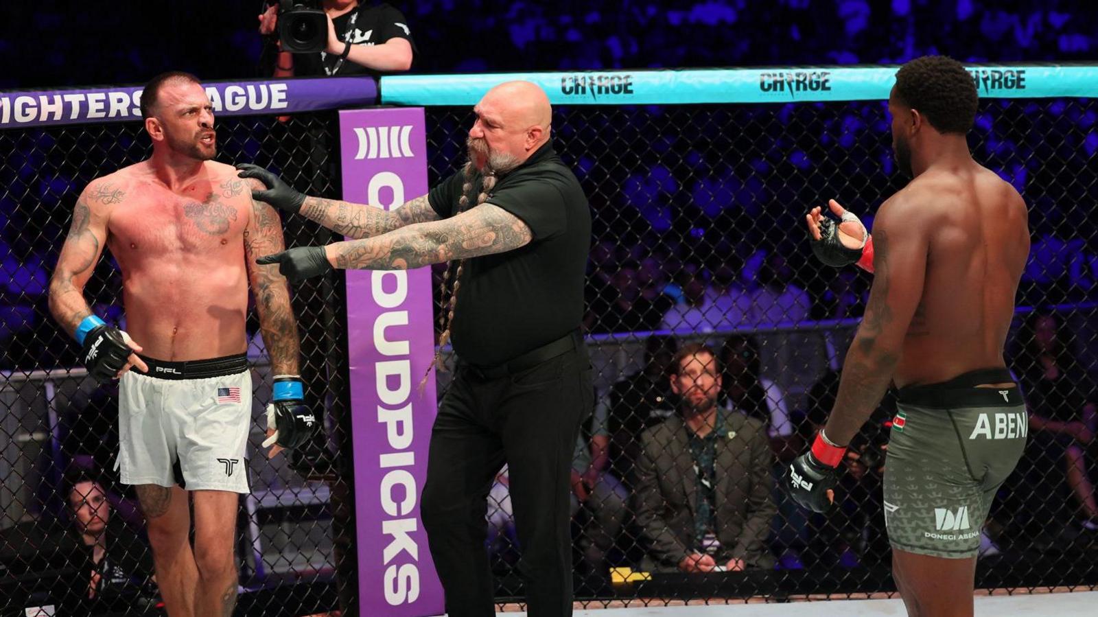 Mike Beltran holds back Joe Schilling as Donegi Abena holds up his hand